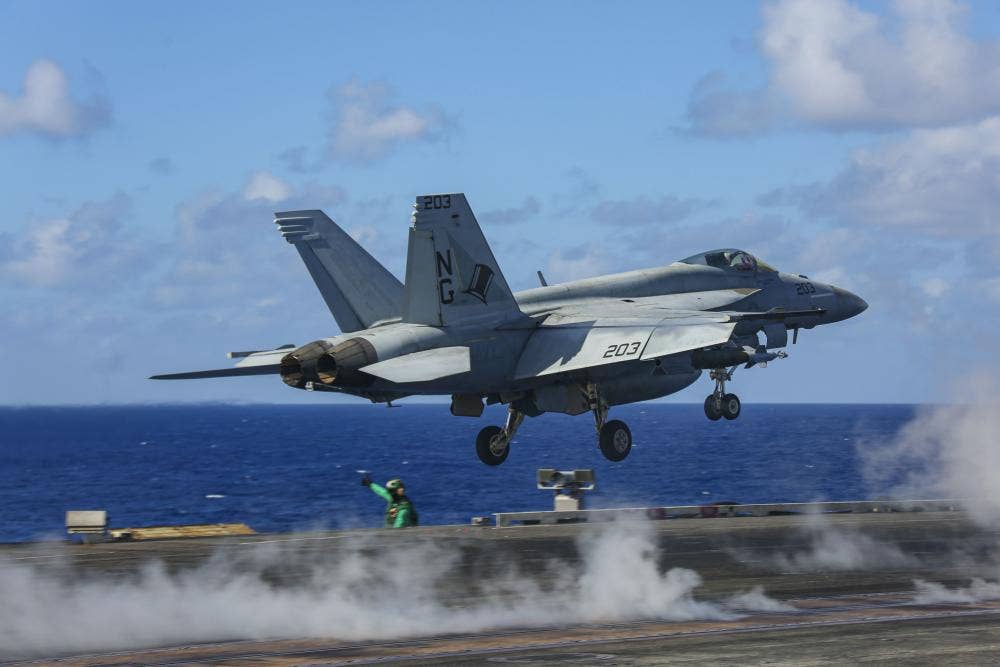 A F/A-18E Super Hornet, assigned to the "Tophatters" of Strike Fighter Squadron (VFA) 14, launches from the flight deck of <em>Nimitz</em>-class aircraft carrier USS <em>Abraham Lincoln</em>.<em> Credit: Mass Communication Specialist 3rd Class Javier Reyes/U.S. Navy</em>