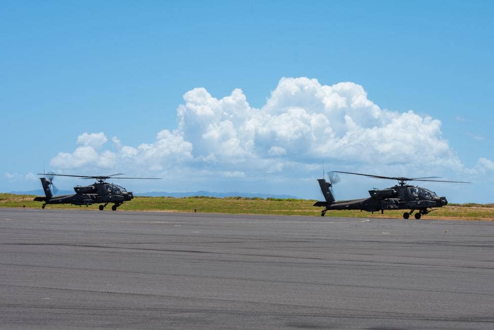 Two AH-64 Apaches, assigned to U.S. Army 25th Combat Aviation Brigade, land on Pacific Missile Range Facility’s (PMRF) flight line in support of Rim of the Pacific (RIMPAC) 2022. <em>Credit: Mass Communication Specialist 2nd Class Samantha Jetzer/U.S. Army</em>