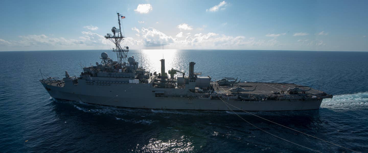 Amphibious transport dock ship the USS <em>Denver</em> (LHD 9) conducts an underway replenishment (UNREP) in 2013. <em>Credit: Mass Communication Specialist 1st Class Joshua Hammond/U.S. Navy</em>