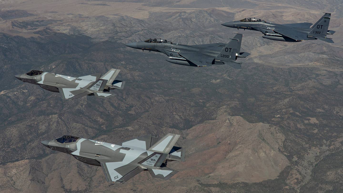 The first two 65th AGRS F-35As fly with a pair of F-15E Strike Eagles. <em>USAF/TSgt Alexandre Montes</em>