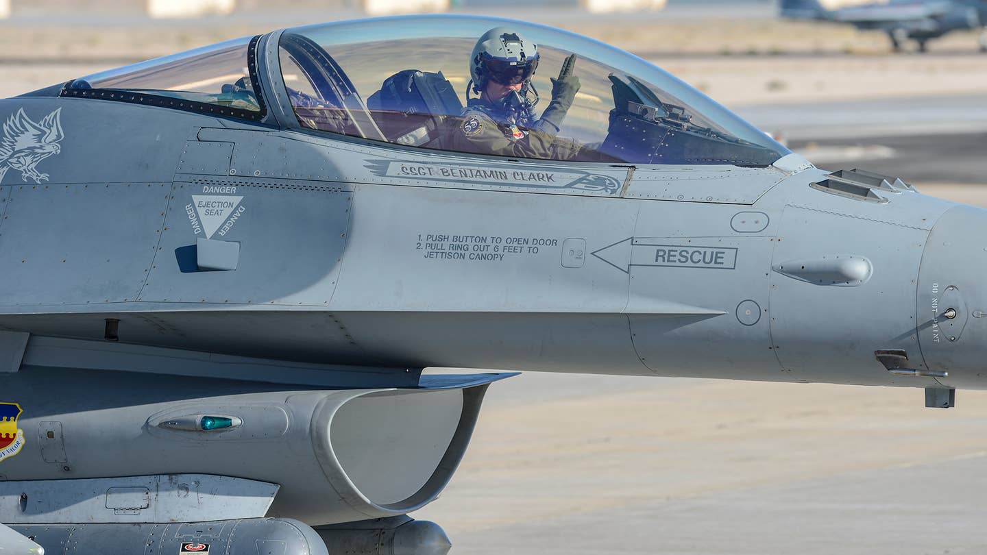 A USAF F-16CM pilot taxiing at Nellis. <em>Jamie Hunter</em>