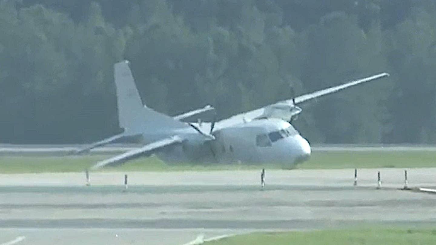 A CASA 212 light cargo plane lies on its side after skidding off the runway during an emergency landing at Raleigh-Durham International Airport on July 29, 2022.