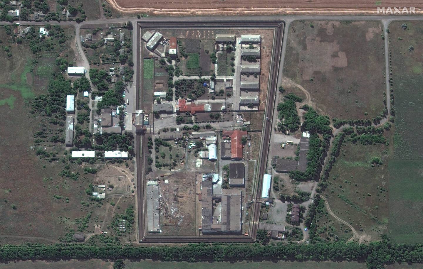 In a subsequent image after an explosion killed more than 50 POWs in the Olenivka prison, the graves from the July 27 image have been largely covered. (Maxar Technologies / July 29, 2022).
