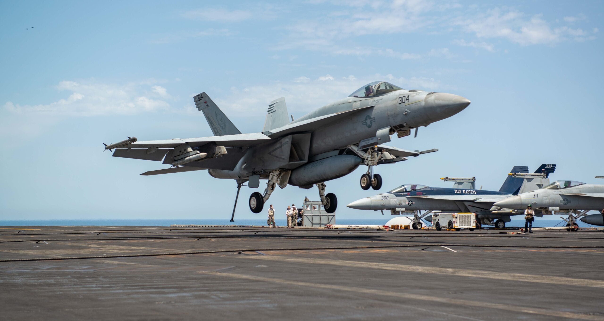 220615-N-ZE328-1227 MEDITERRANEAN SEA (June 15, 2022) An F/A-18E Super Hornet, attached to the “Blue Blasters” of Strike Fighter Squadron (VFA) 34, lands on the flight deck of USS Harry S. Truman (CVN 75), June 15, 2022. The Harry S. Truman Carrier Strike Group is on a scheduled deployment in the U.S. Naval Forces Europe area of operations, employed by U.S. Sixth Fleet to defend U.S., allied and partner interests. (U.S. Navy photo by Mass Communication Specialist 2nd Class Kelsey Trinh)