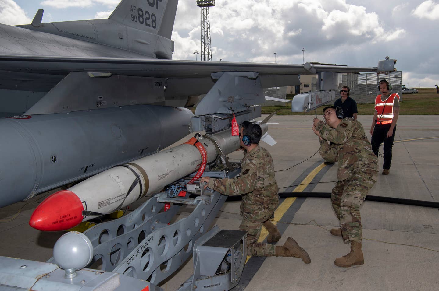 A U.S. Air Force weapons load crew chief loads an inert AGM-88 High-speed Anti-Radiation Missile, or HARM, onto an F-16 Fighting Falcon, at Spangdahlem Air Base, Germany. <em>U.S. Air Force photo by Senior Airman Kyle Cope</em>