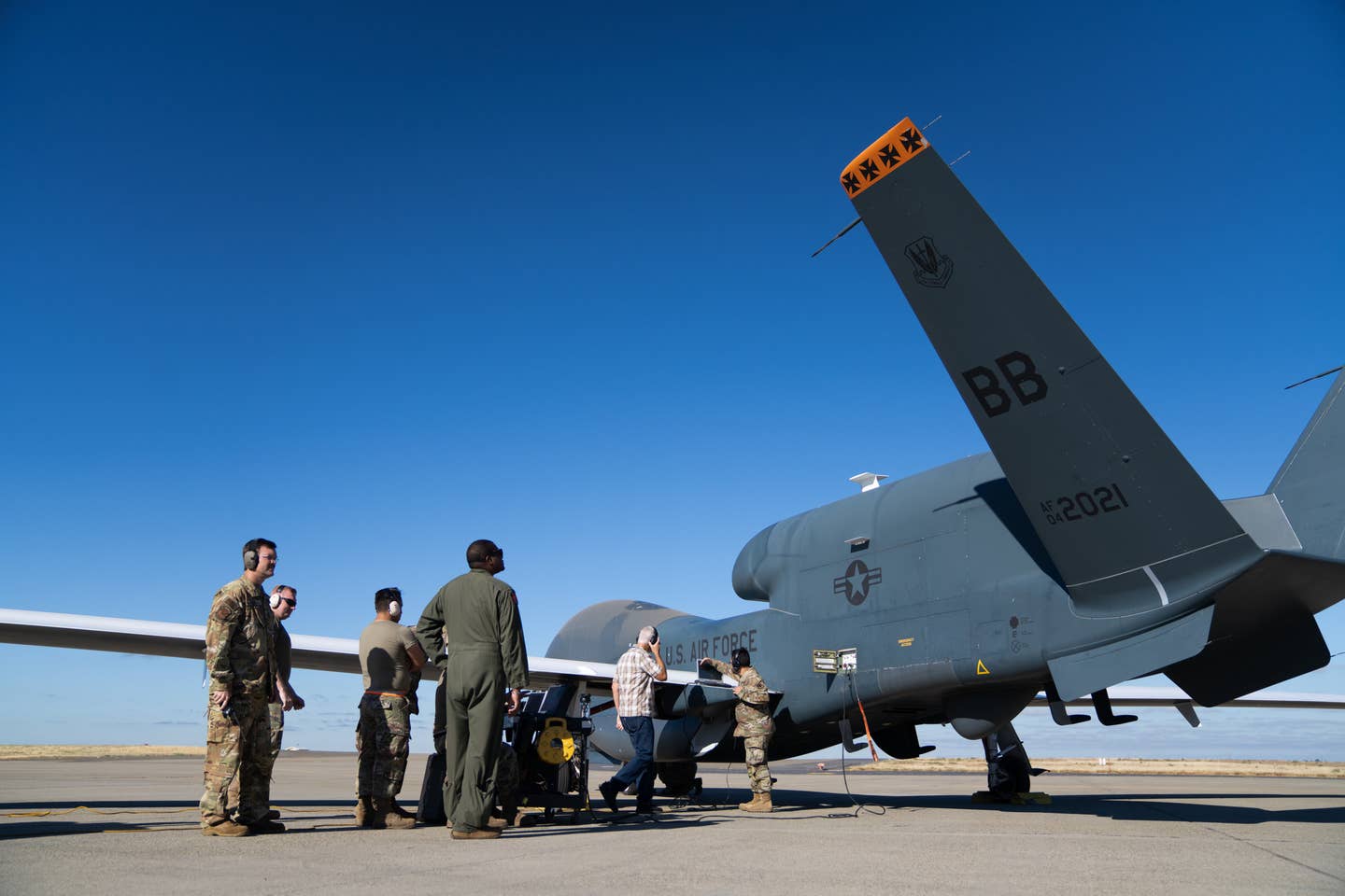 Members assigned to the 12th Reconnaissance Squadron and 319th Aircraft Maintenance Squadron Detachment 1 conduct preflight procedures on an RQ-4 Global Hawk Block 30 July 7, 2022, at Beale Air Force Base California. <em>Credit: Staff Sgt. Ramon A. Adelan/U.S. Air Force</em>