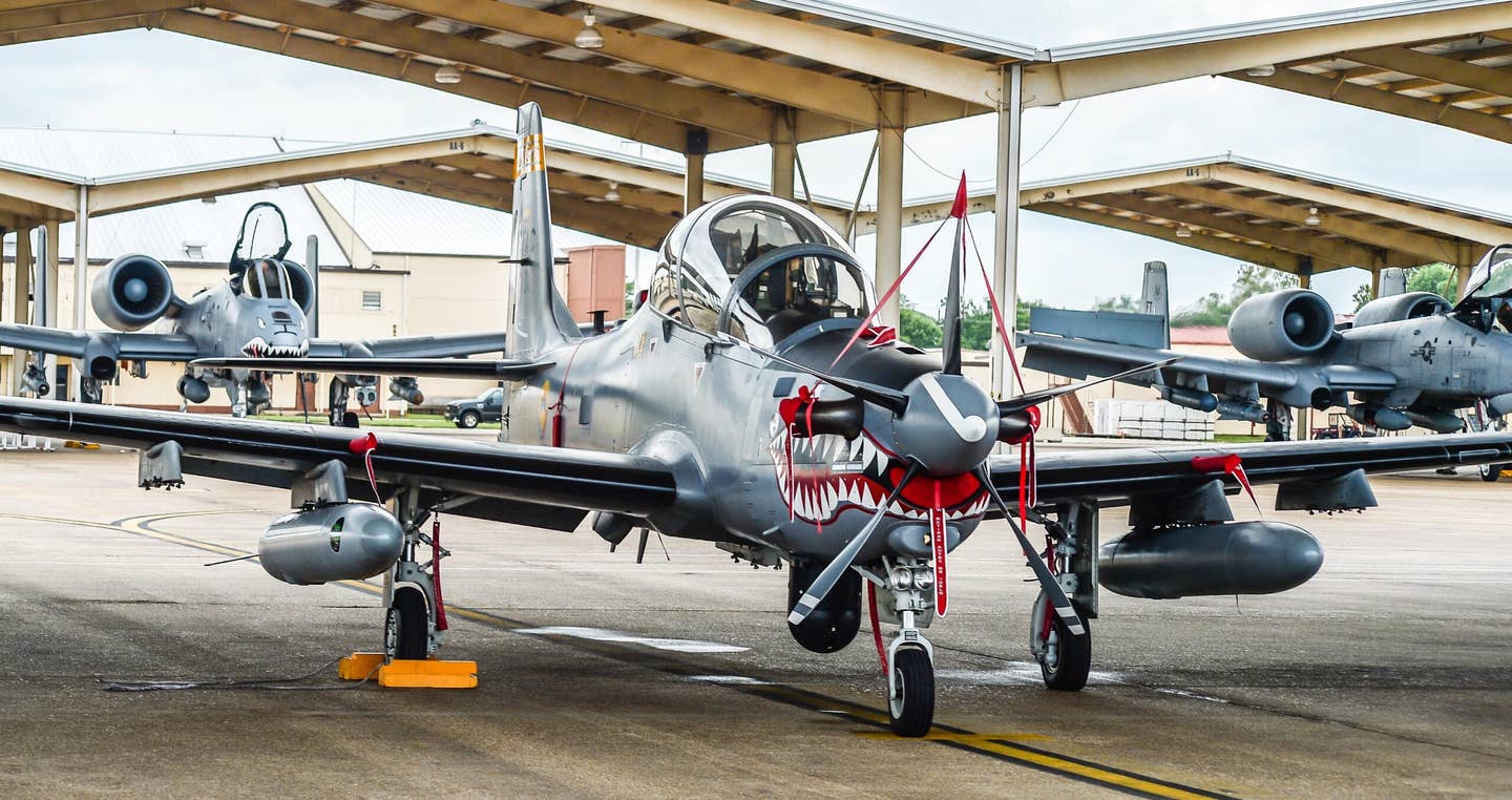 A Colombian Air Force A-29B Super Tucano sits in front of two A-10 Thunderbolt II aircraft during Exercise Green Flag East at Barksdale Air Force Base, Louisiana, in August 2016. <em>U.S. Air Force photo/Senior Airman Mozer O. Da Cunha</em>