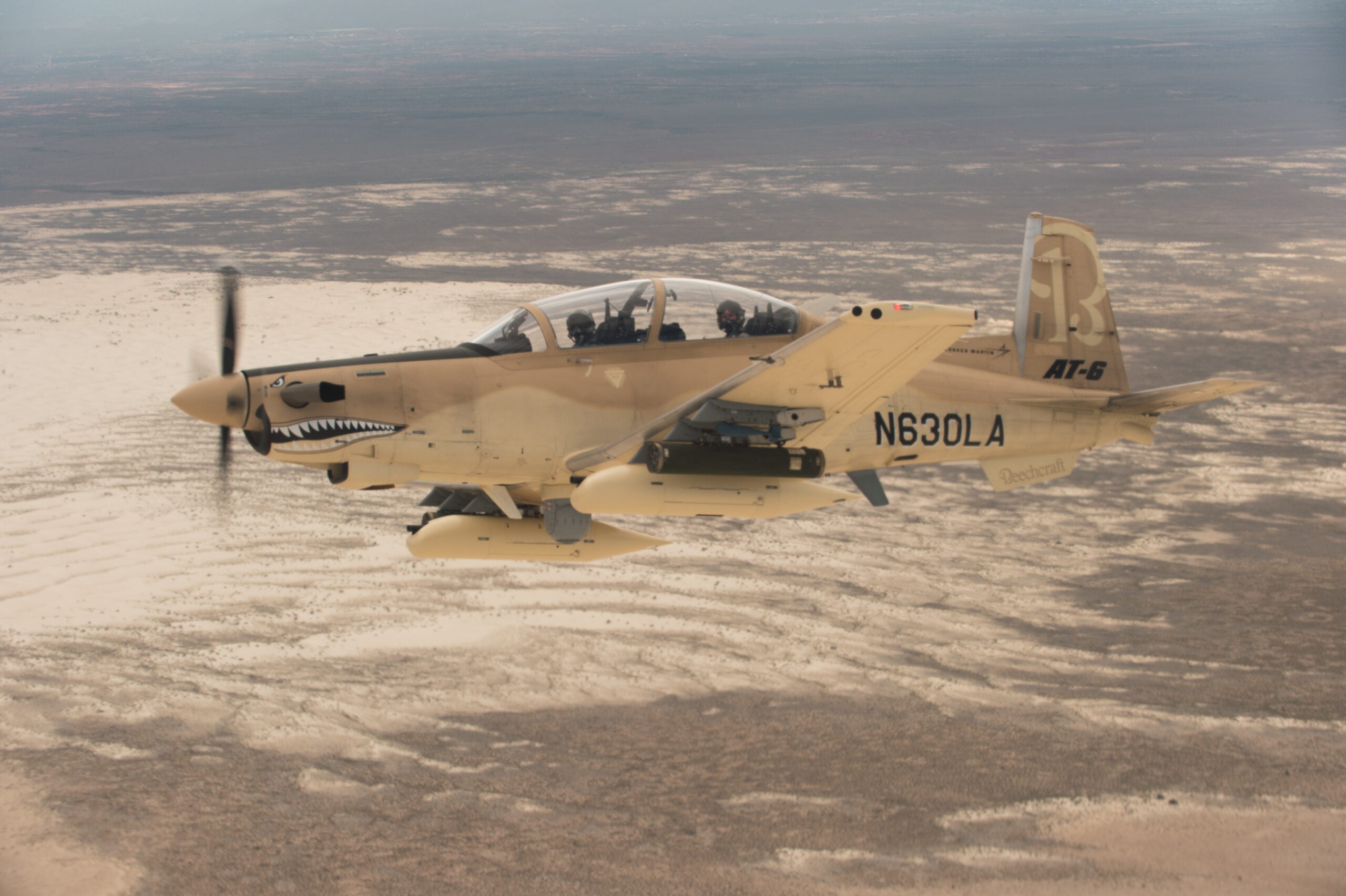 HOLLOMAN AIR FORCE BASE, N.M. (July 31, 2017) A Beechcraft AT-6 experimental aircraft flies over White Sands Missile Range. The AT-6 is participating in the U.S. Air Force Light Attack Experiment (OA-X), a series of trials to determine the feasibility of using light aircraft in attack roles. (U.S. Air Force Photo by Ethan D. Wagner)