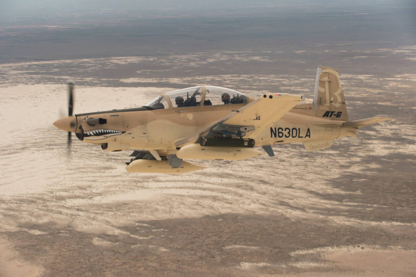 A Beechcraft AT-6 experimental aircraft flies over White Sands Missile Range during the second phase of the Light Attack Experiment in July 2017. <em>U.S. Air Force Photo by Ethan D. Wagner</em>