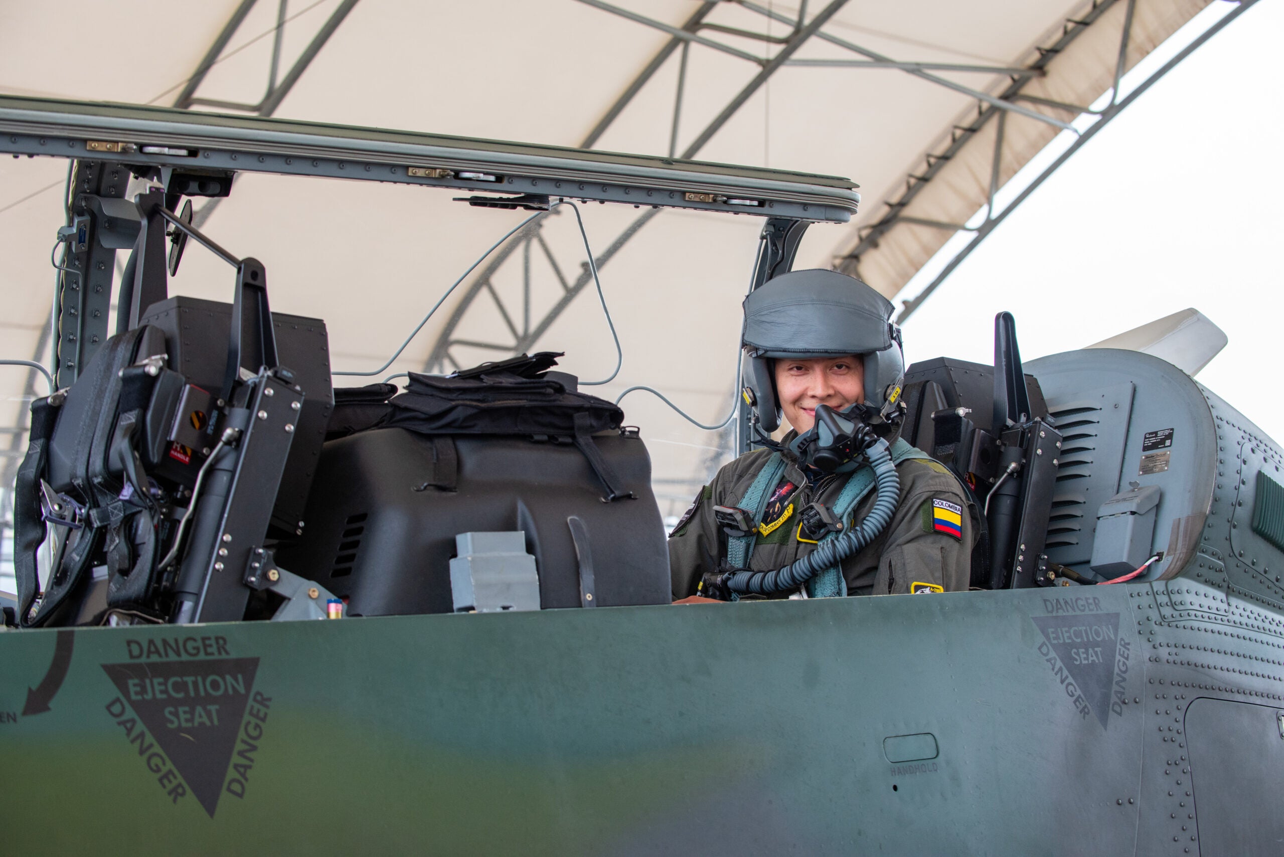 Colombian Air Force Carreno “Tifon”, copilot, poses for a photograph before an experimentation flight in the AT-6E Wolverine at Moody Air Force Base, Georgia, April 14, 2022. The flight focused on digitally tracking friendly forces and potential enemy movement using Airborne Extensible Relay Over-Horizon Network software.  (U.S. Air Force photo by Airman 1st Class Courtney Sebastianelli)