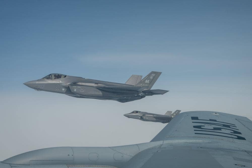 U.S. Air Force F-35 Lightning IIs assigned to the 354th Fighter Wing, Eielson Air Base, Alaska, fly next to a KC-135 Stratotanker assigned to the 909th Aerial Refueling Squadron, Kadena Air Base, Japan, during RED FLAG-Alaska 22-3 over the Joint Pacific Alaska Range Complex, Alaska, Aug. 1, 2022. (U.S. Air Force photo by Airman 1st Class Andrew Britte)