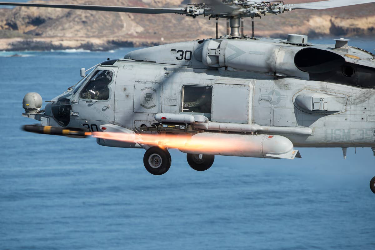 An MH-60R Seahawk helicopter, assigned to Helicopter Maritime Strike Squadron (HSM) 35, fires an AGM-114M Hellfire missile near San Clemente Island, Calif., during a live-fire combat training exercise. (U.S. Navy Combat Camera photo by Mass Communication Specialist 2nd Class Arthurgwain L. Marquez/Released)