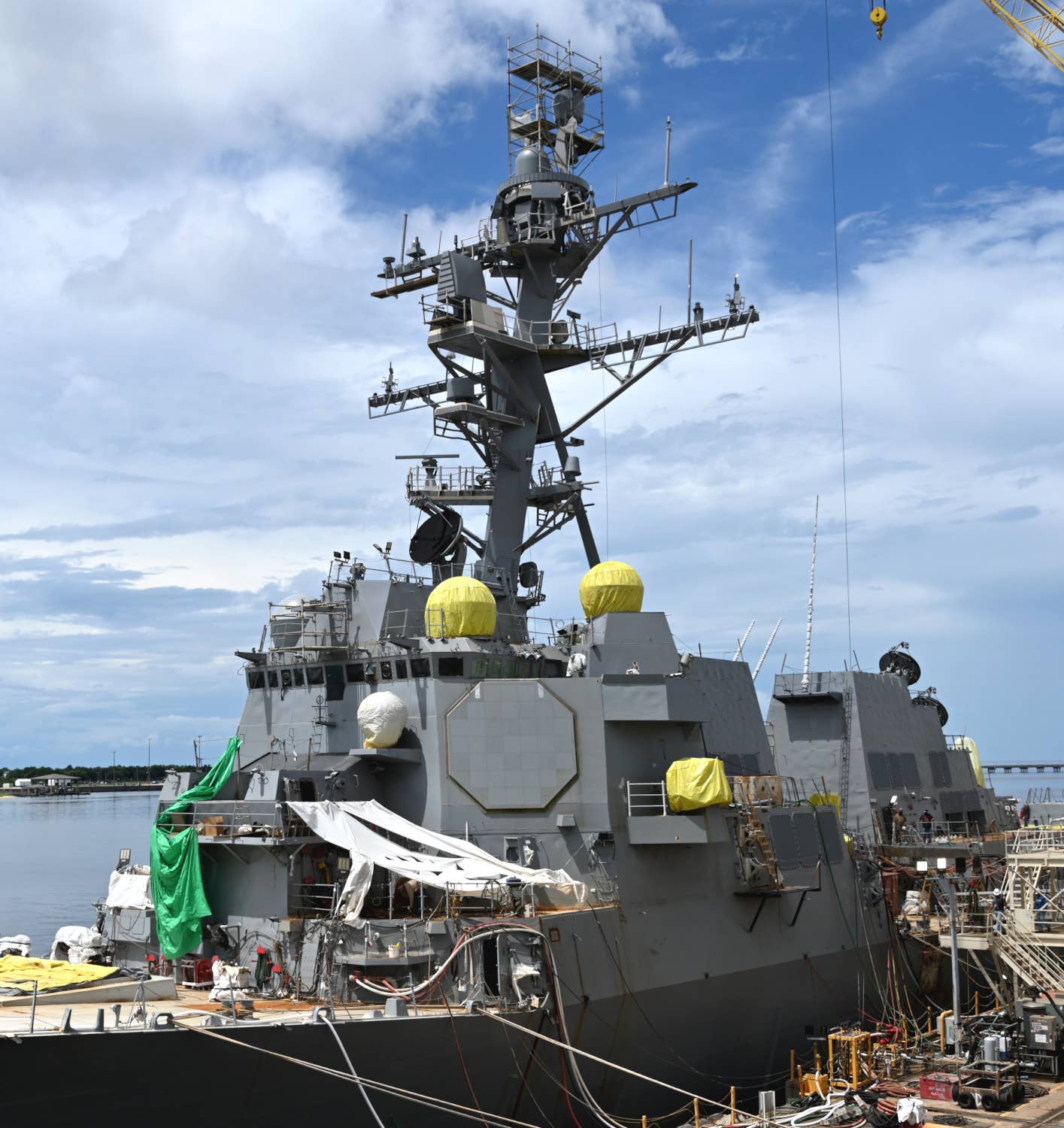 Another view of the future USS Jack H. Lucas. The shrouds seen covering various antenna domes associated with the ship's communications and data-sharing suite, as well as a portion of its Surface Electronic Warfare Improvement Program (SEWIP) electronic warfare system under the bridge wing, are installed for temporary weather protection. <em>Chris Cavas photo</em>
