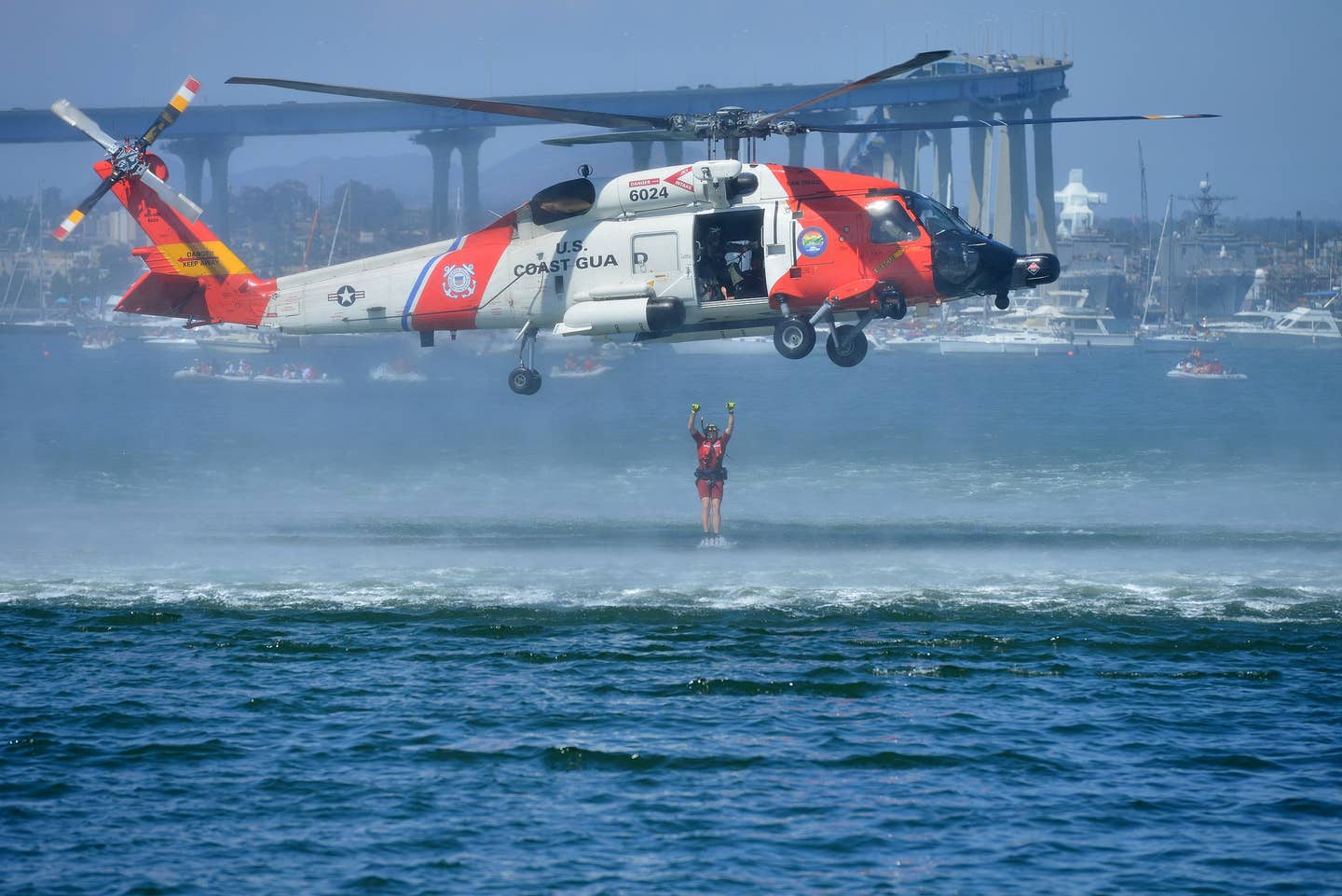 Petty Officer 2nd Class Ryan Pierce, an aviation survival technician at Coast Guard Sector San Diego, deploys from an MH-60 Jayhawk helicopter during a search and rescue demonstration in Glorietta Bay, in Coronado, Calif., July 4, 2015. During the demonstration, Pierce and the Jayhawk crew simulated various rescue techniques during search and rescue cases. (U.S. Coast Guard photo by Petty Officer 1st Class Rob Simpson)