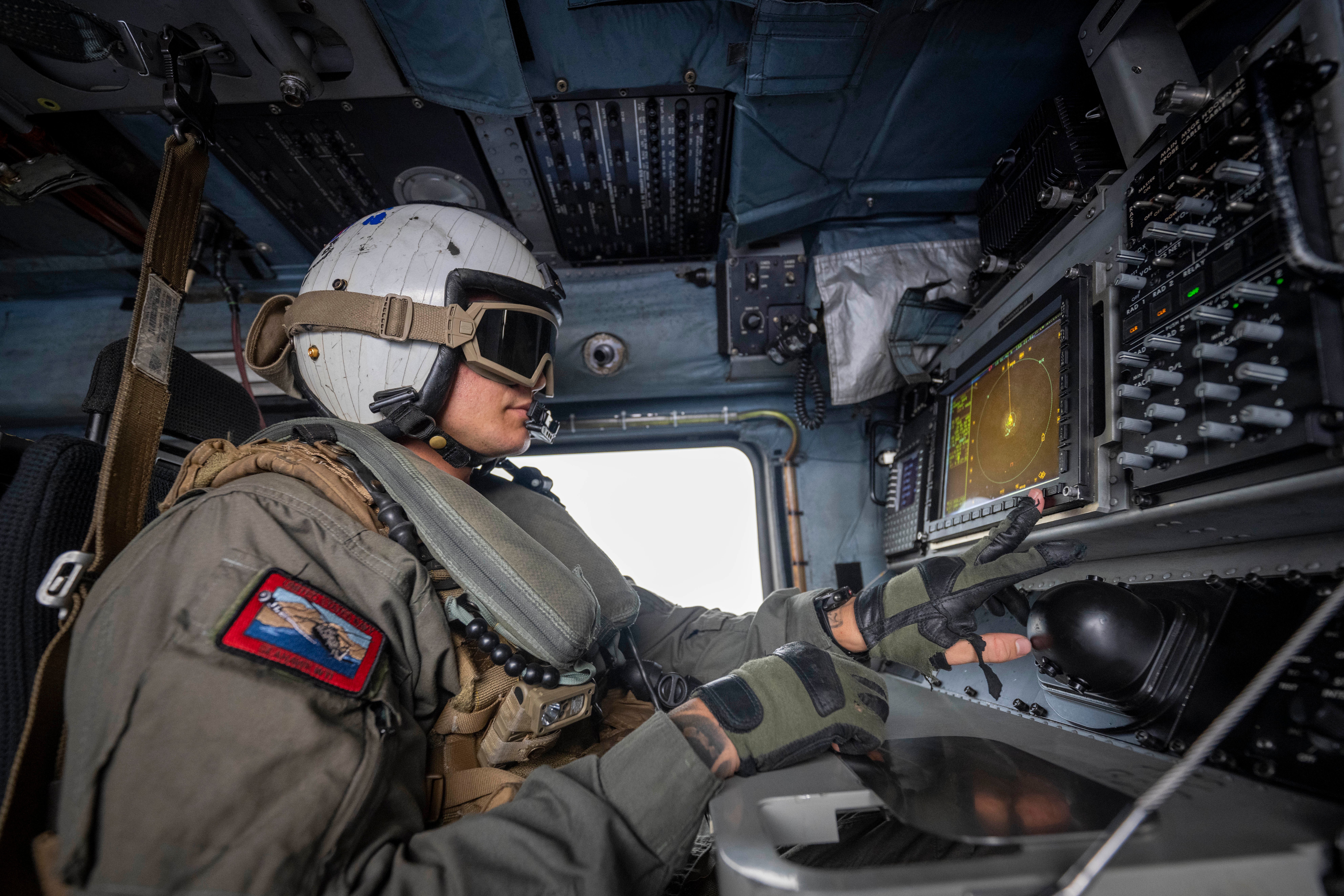PACIFIC OCEAN (July 30, 2022) Naval Aircrewman (Helicopter) 1st Class Humberto Alba, attached to Helicopter Maritime Strike Squadron (HSM) 37, checks a radar during flight operations during Rim of the Pacific (RIMPAC) 2022. Twenty-six nations, 38 ships, three submarines, more than 170 aircraft and 25,000 personnel are participating in RIMPAC from June 29 to Aug. 4 in and around the Hawaiian Islands and Southern California. The world's largest international maritime exercise, RIMPAC provides a unique training opportunity while fostering and sustaining cooperative relationships among participants critical to ensuring the safety of sea lanes and security on the world's oceans. RIMPAC 2022 is the 28th exercise in the series that began in 1971. (U.S. Coast Guard photo by Petty Officer 3rd Class Taylor Bacon)