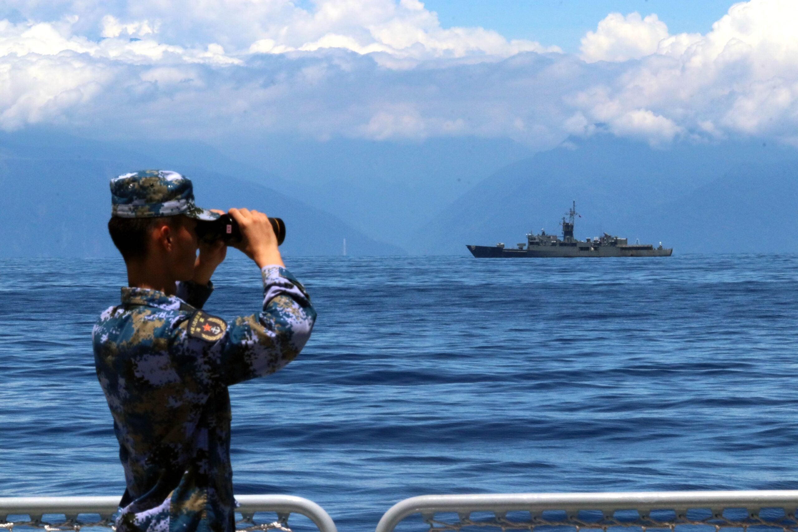 A soldier looks through binoculars during combat exercises and training of the navy of the Eastern Theater Command of the Chinese People's Liberation Army PLA in the waters around the Taiwan Island, Aug. 5, 2022. The Eastern Theater Command on Friday continued joint combat exercises and training in the waters and airspace around the Taiwan Island. (Photo by Lin Jian/Xinhua via Getty Images)