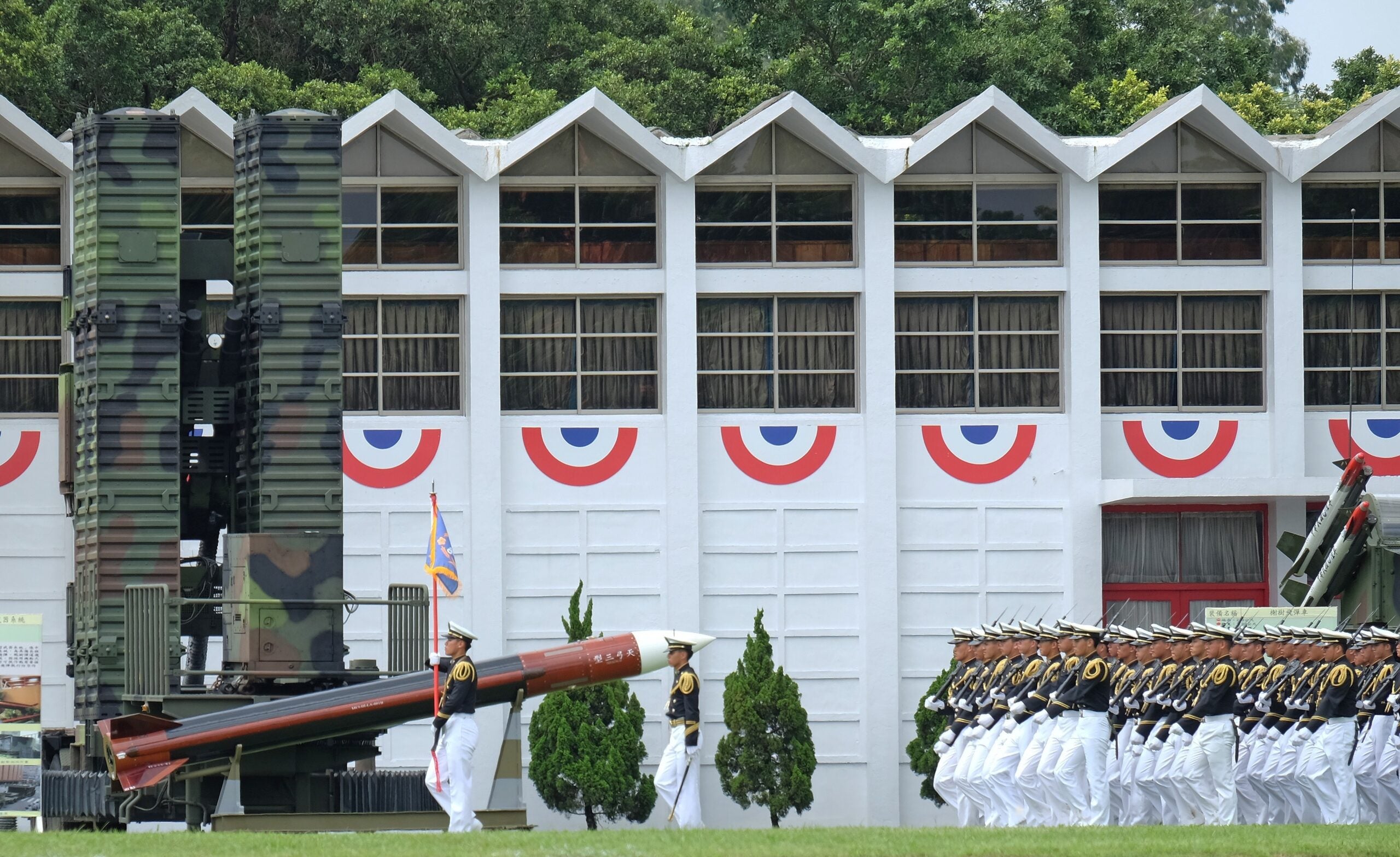 Students from the Taiwan Military Academy, known as former Whampoa military academy, walk past a model of a home made Tien Kung III missile in southern Kaohsiung on June 16, 2014. More then 1,200 military students have graduated from the Taiwan Military Academy as President Ma Ying-jeou presided over a ceremony to mark the 90th anniversary of the Whampoa military academy. AFP PHOTO / SAM YEH        (Photo credit should read SAM YEH/AFP via Getty Images)