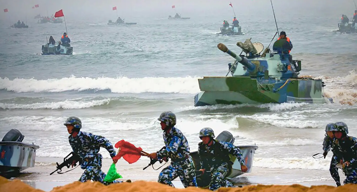 Chinese marines race ashore accompanied by amphibious tanks during a beach assault exercise. <em>PLA</em>