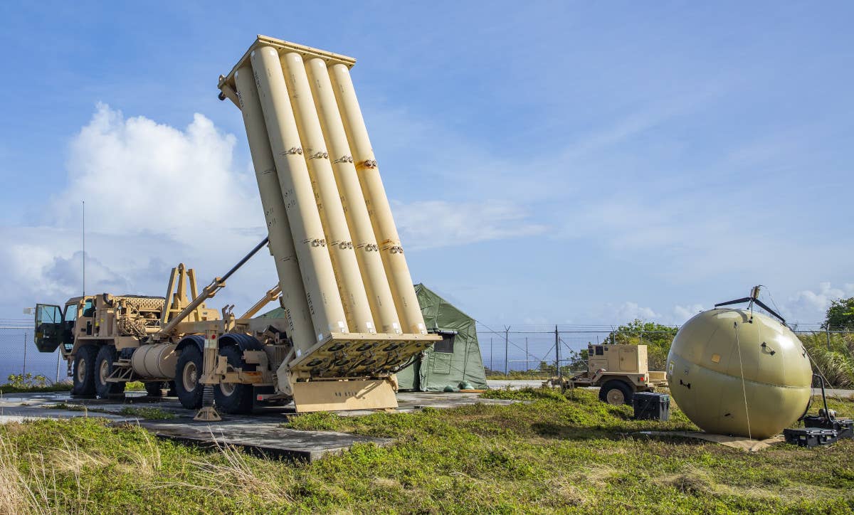 A THAAD launcher, at left, along with a Transportable Tactical Command Communications (T2C2) node, at right, among other equipment, emplaced at Rota International Airport on Rota Island during a test in 2022. <em>US Army</em>