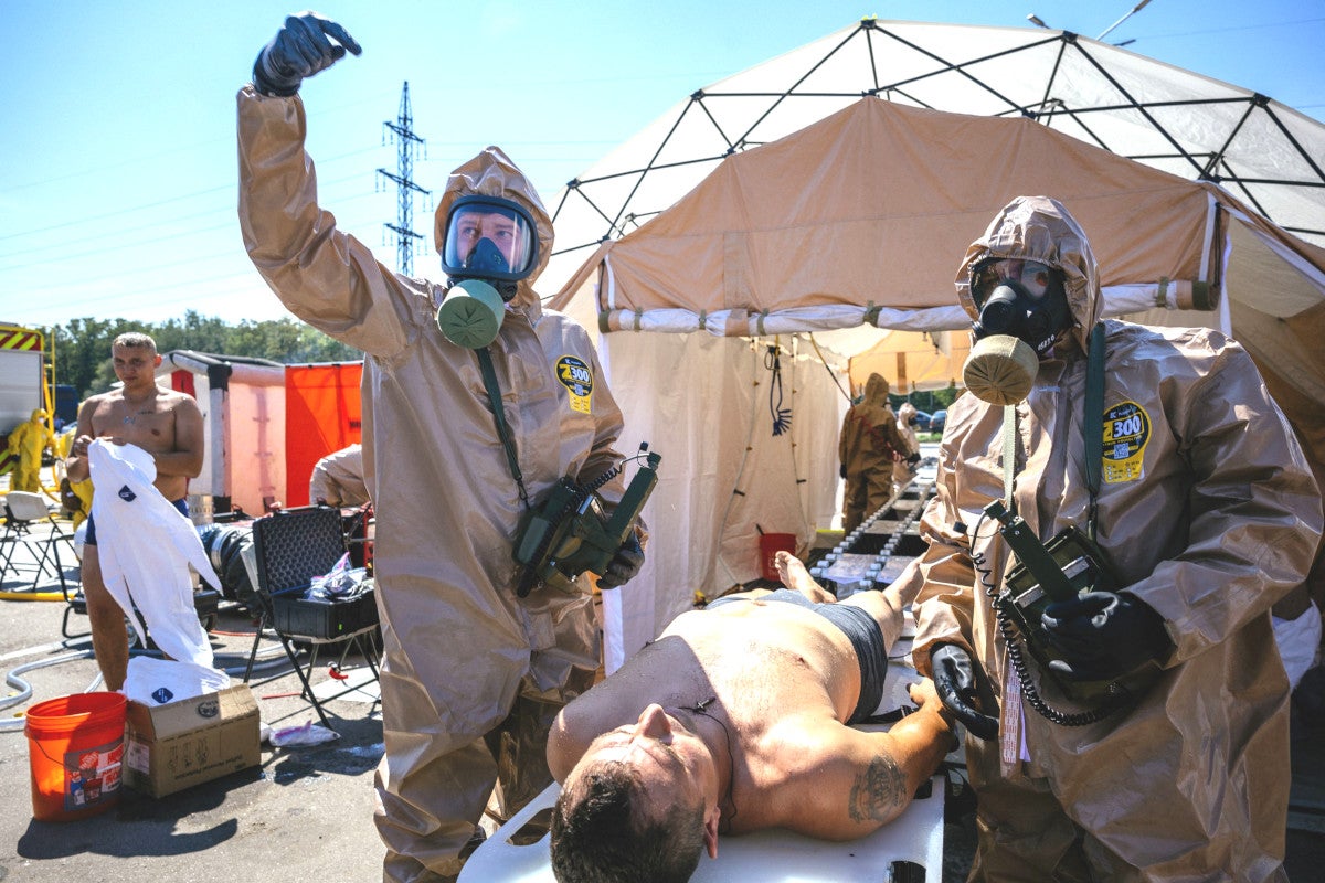 TOPSHOT - Ukrainian Emergency Ministry rescuers attend an exercise in the city of Zaporizhzhia on August 17, 2022, in case of a possible nuclear incident at the Zaporizhzhia nuclear power plant located near the city. - Ukraine remains deeply scarred by the 1986 Chernobyl nuclear catastrophe, when a Soviet-era reactor exploded and streamed radiation into the atmosphere in the country's north. The Zaporizhzhia nuclear power plant in southern Ukraine was occupied in the early days of the war and it has remained in Russian hands ever since. (Photo by Dimitar DILKOFF / AFP) (Photo by DIMITAR DILKOFF/AFP via Getty Images)