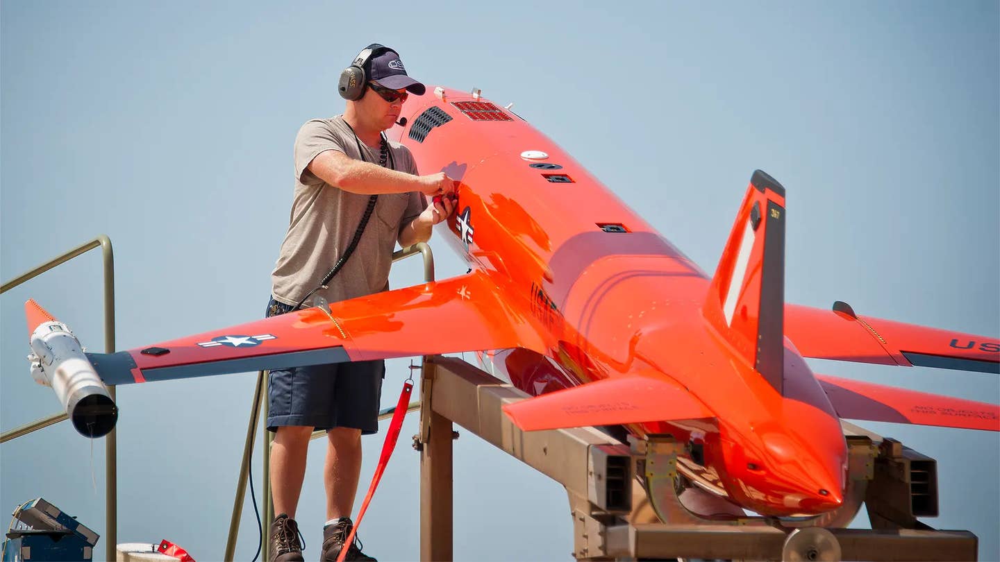 A technician works on a BQM-167A, a subsonic aerial target drone currently in US Air Force service. <em>USAF</em>