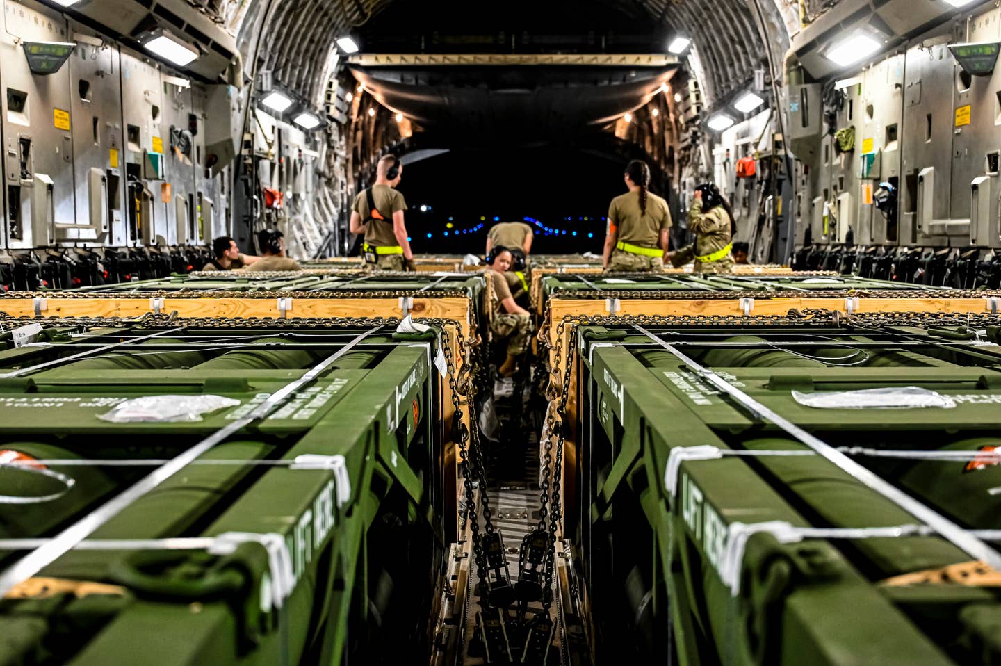 Airmen assigned to the 305th Aerial Port Squadron, upload Guided Multiple Launch Rocket System munitions onboard a Boeing 767 at Joint Base McGuire-Dix-Lakehurst, N.J., Aug. 13, 2022. USAF Photo by Senior Airman Matt Porter