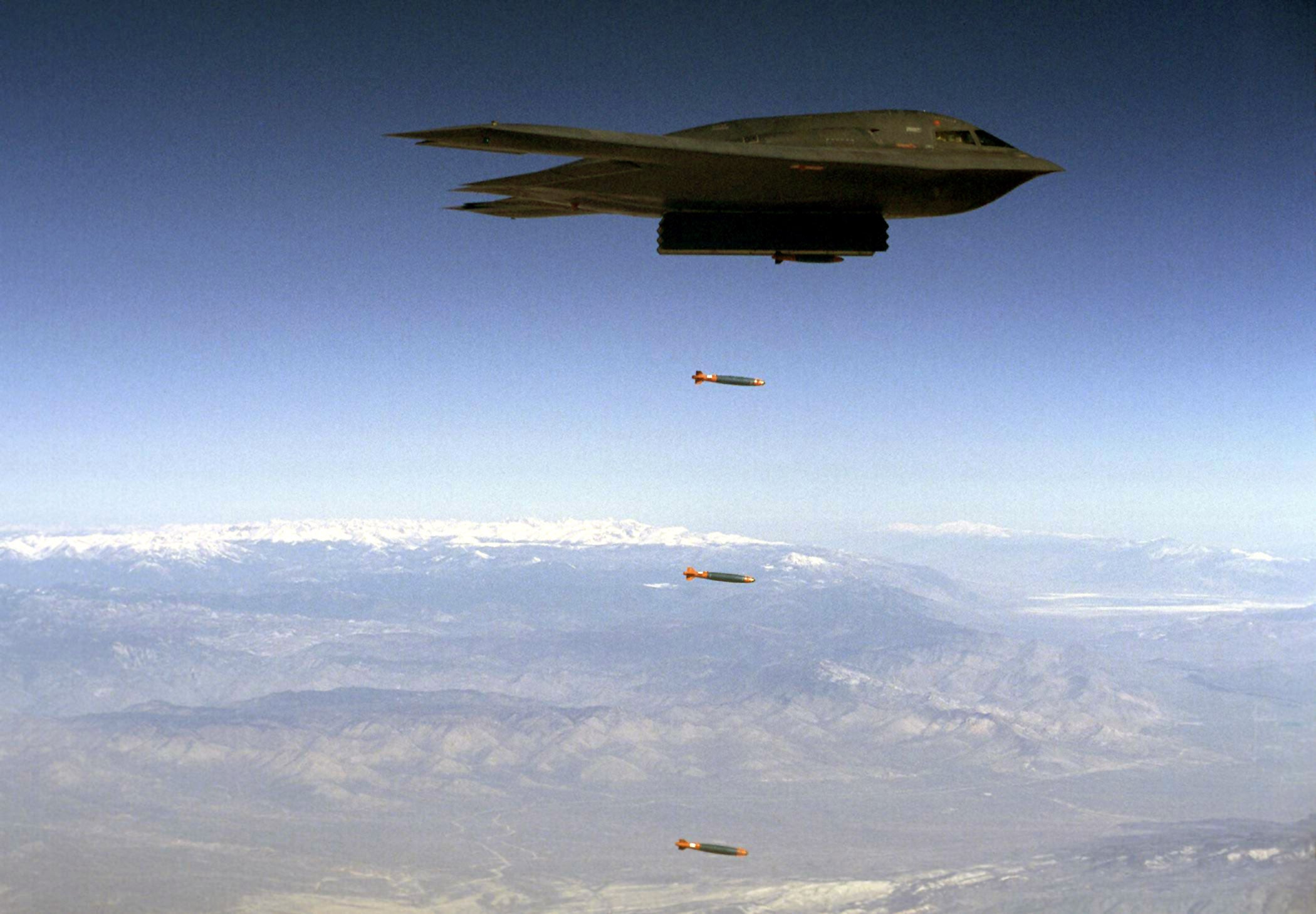EDWARDS AIR FORCE BASE, Calif. -- A B-2 Spirit drops Joint Direct Attack Munitions separation test vehicles over Edwards in an earlier test.  On Aug. 6, a B-2 dropped 80 inert JDAMs during a test to increase the B-2's operational capability.  (Courtesy photo)