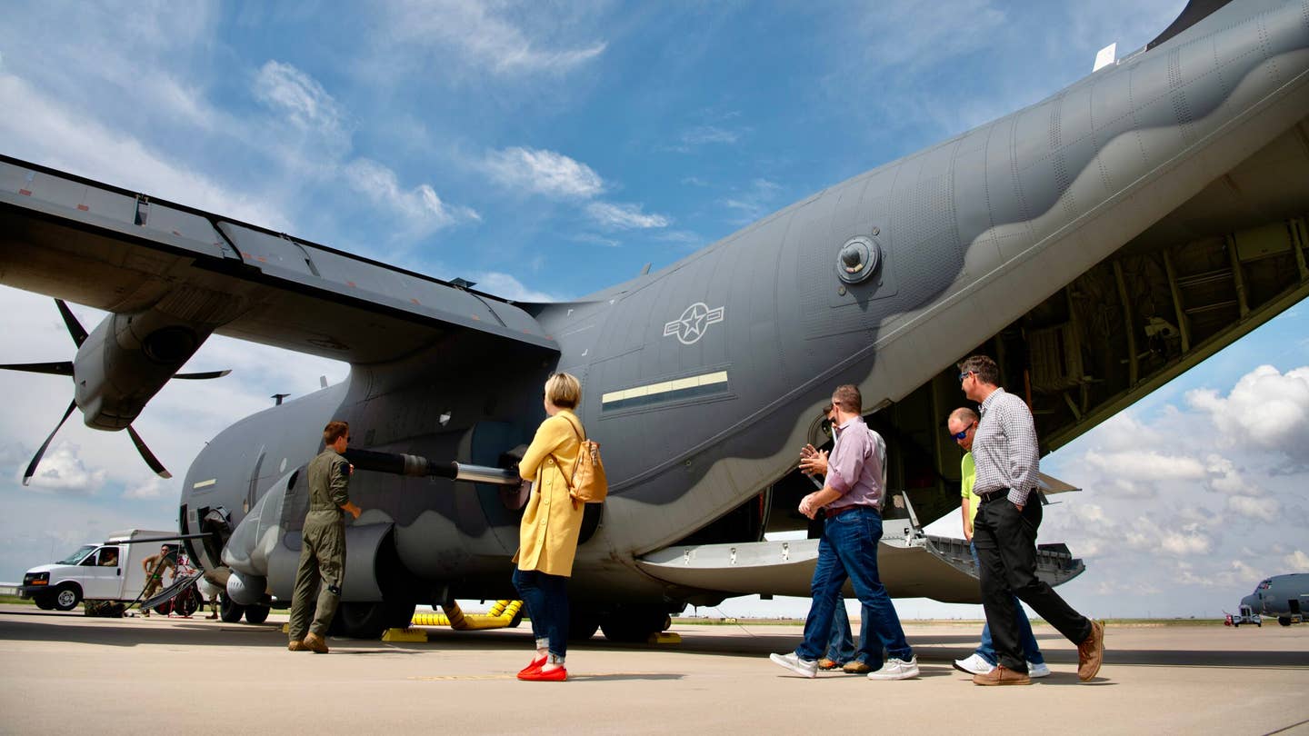 City of Clovis 'honorary commanders' receive a tour and safety brief on a U.S. Air Force 17th Special Operations Squadron AC-130J Ghostrider gunship during an honorary commander flight event on Aug. 24, 2022, at Cannon Air Force Base, New Mexico. The new 105mm howitzer is seen sticking out of the rear left side of the fuselage. <em>USAF</em>