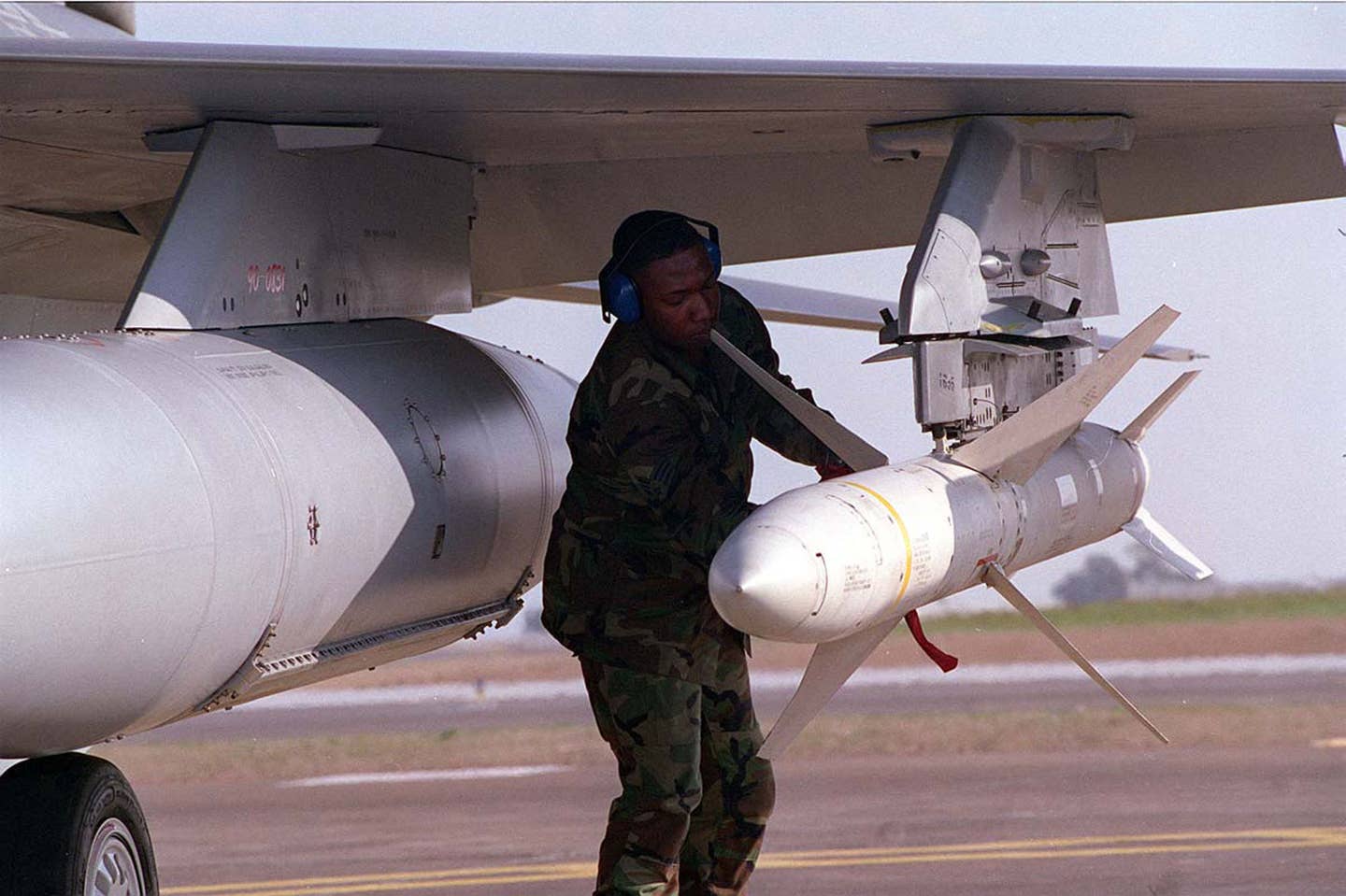 A U.S. Air Force weapons technician secures an AGM-88 HARM after an F-16CJ lands at Incirlik Air Base, Turkey. <em>Photo By USAF/Getty Images</em>