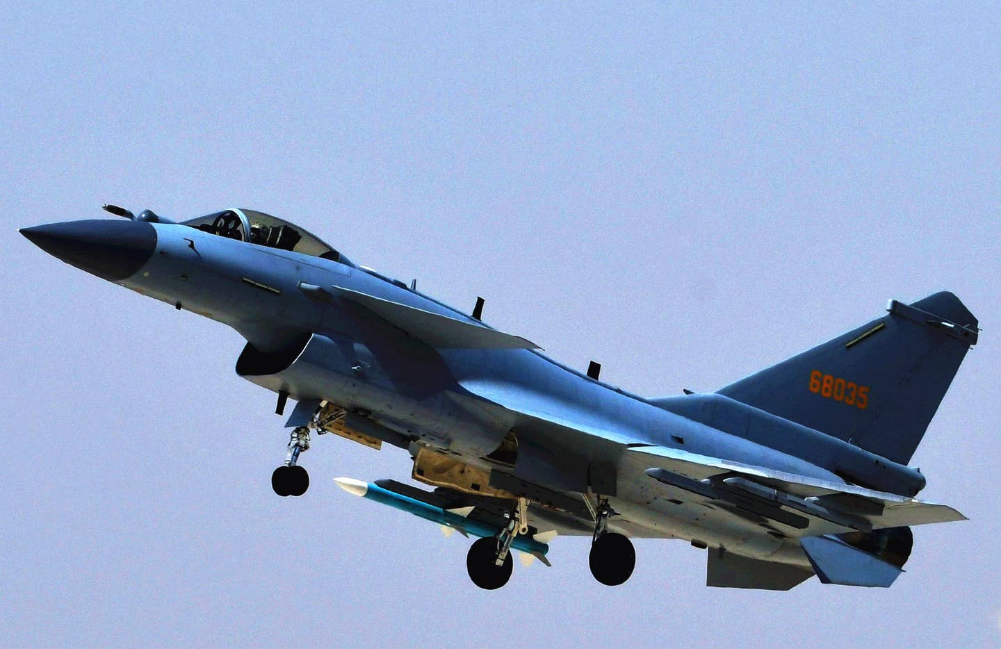 A PLAAF J-10C conducts a training sortie, with a single inert PL-12 round carried under the starboard wing. <em>Xinhua/Liu Chuan via Getty Images</em>