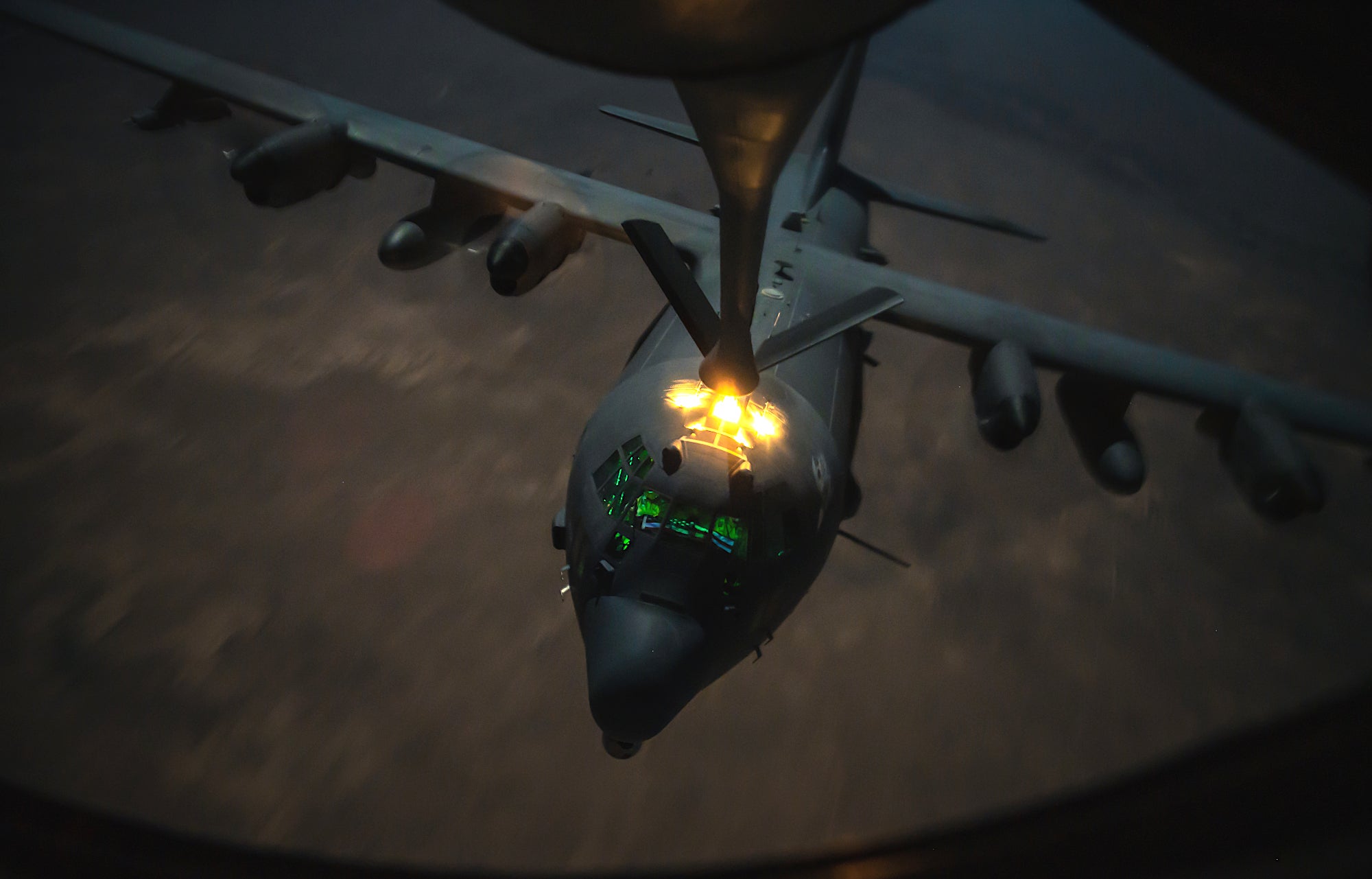 A U.S. Air Force AC-130J Ghostrider receives fuel from a U.S. Air Force KC-135 Stratotanker, assigned to the 340th Expeditionary Aircraft Refueling Squadron, during a night-time air refueling mission over Southwest Asia, Dec. 25, 2020. The KC-135 Stratotanker delivers U.S. Air Forces Central a global aerial refueling capability to support joint and coalition aircraft throughout the U.S. Central Command area of responsibility. (U.S. Air Force photo by Staff Sgt. Trevor T. McBride)