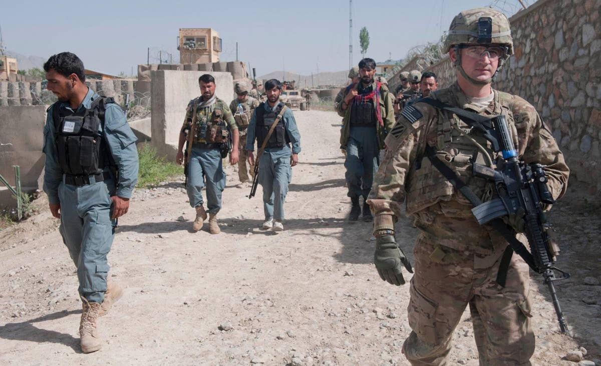 US Army soldiers and local Afghan police conduct a combined patrol in Logar Province in 2013. <em>US Army</em>