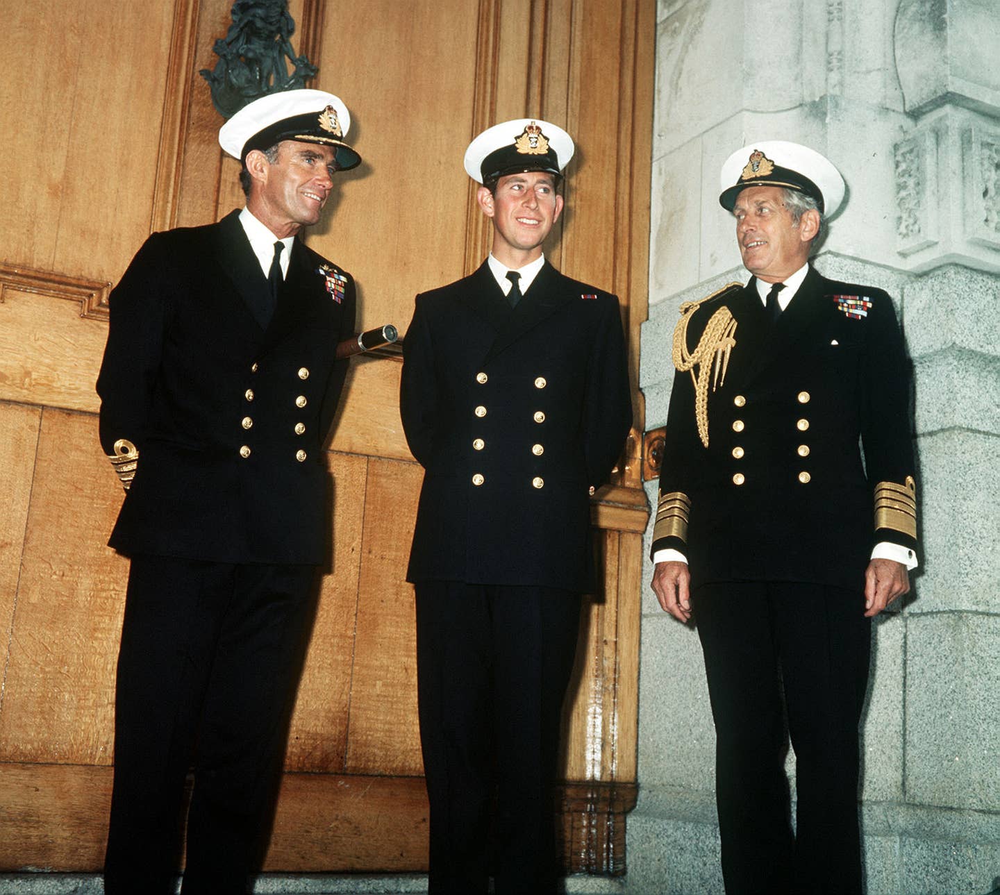 The then-Prince of Wales with Captain Allan Tait (L) and Admiral Sir Horace Law at the Brittania Ryal Naval College, Dartmouth, where the prince began a six-week graduate course. (Royal family photo)