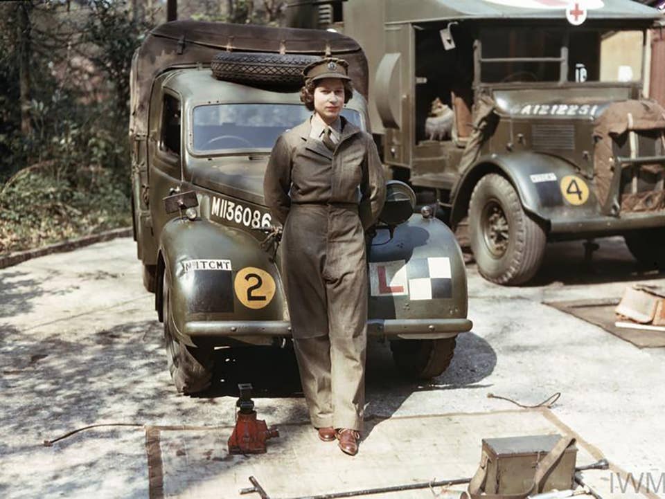 Auxiliary Territorial Service: Princess Elizabeth, a 2nd Subaltern in the ATS, wearing overalls and standing in front of an L-plated truck. In the background is a medical lorry. Copyright: © IWM.