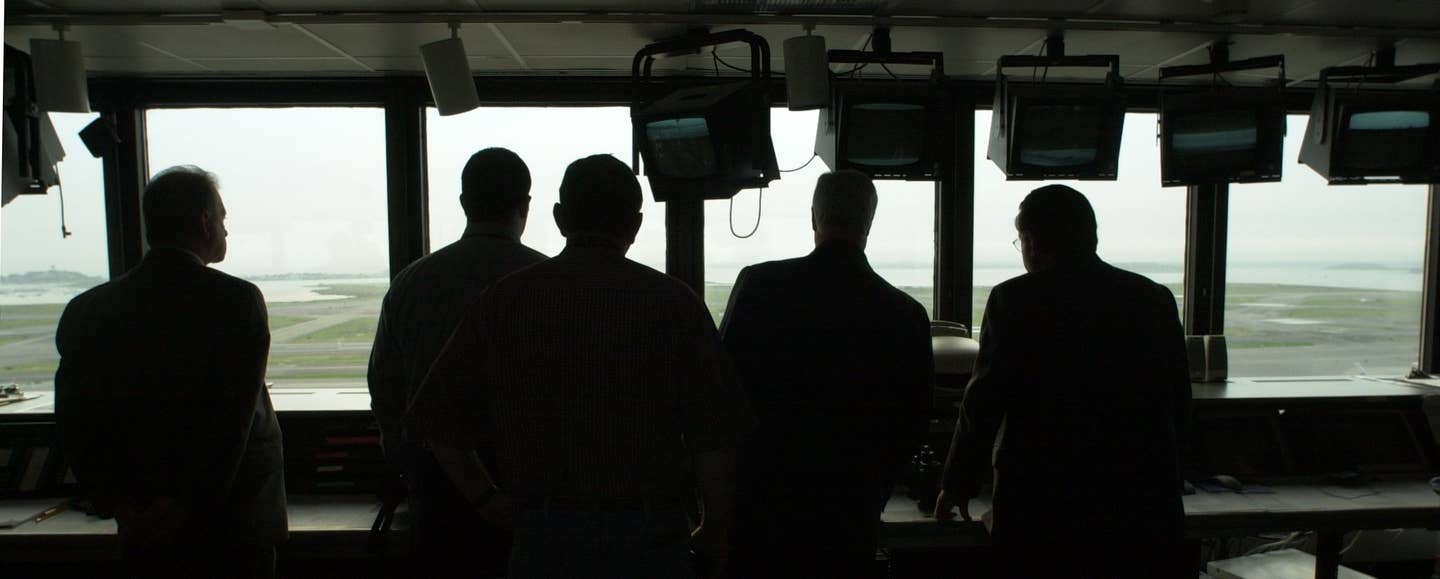 Workers at the Massport Operations Communications Center watch as Logan Airport resumes activity after a 60-second closure in memory of the events of September 11, 2001. <em>Credit: Photo by John Blanding/The Boston Globe via Getty Images</em>
