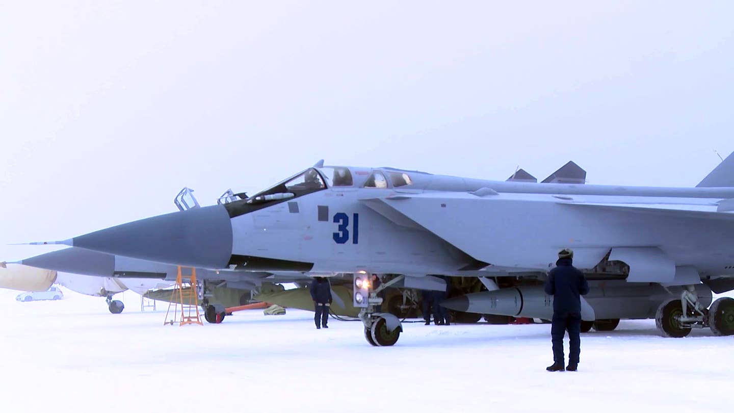 Another view of the MiG-31K/I flight line in February 2022, with the nearest jet ready to depart with a Kinzhal missile. <em>Russian Ministry of Defense</em>
