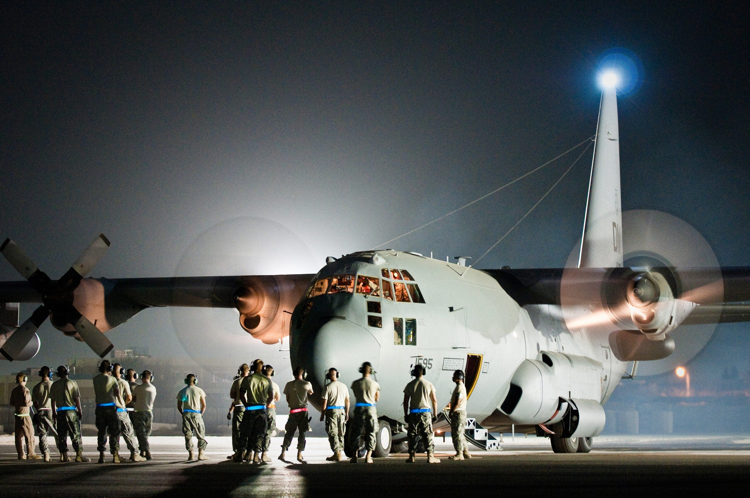 Maintenance troops and aircrew members prepate a U.S. Air Force EC-130H aircraft for its final departure from an undisclosed air base here Aug. 29, 2010. The plane's unit, the 43rd Expeditionary Electronic Combat Sqaudron, has been part of the 386th Air Expeditionary Wing for six and a half years but is moving to another base in the U.S. Central Command area of responsibility becuase of the responsible drawdown of forces in Iraq. The EC-130H Compass Call aircraft provides U.S. forces with the ability to jam enemy communications.