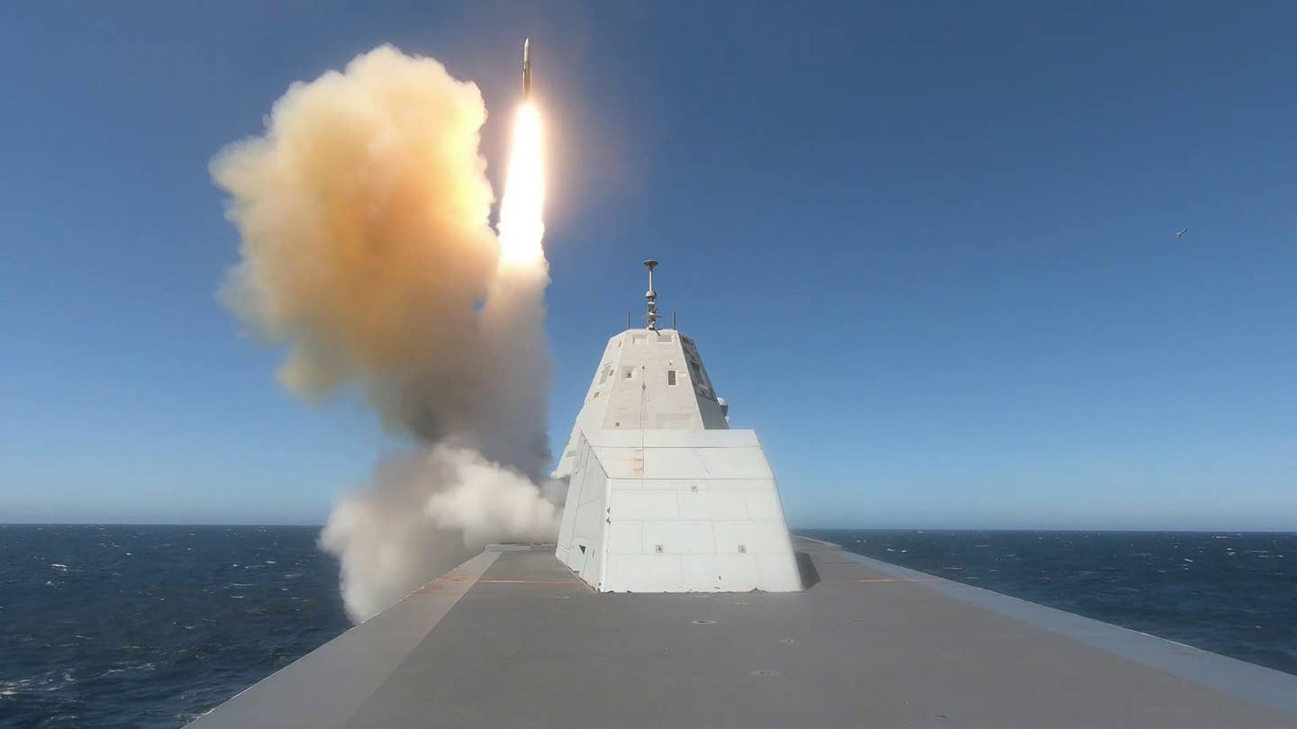 The guided-missile destroyer USS <em>Zumwalt</em> (DDG-1000) fires an SM-2 Block IIIAZ surface-to-air missile from one of its Mk 57 VLS arrays during an exercise at the Point Mugu Test Range in the Pacific Ocean. <em>Credit: U.S. Navy photo by Lt. j.g. Mary Kierstead</em>