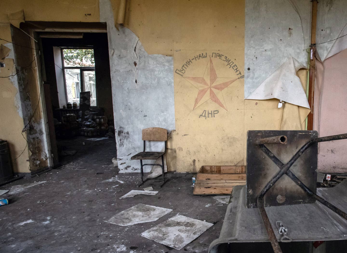 A photograph taken on September 20, 2022, showing a slogan on a wall in a school, written by the self-proclaimed Donetsk People’s Republic (DNR), which reads in Russian “Putin is our president.” The school in Mala Komyshuvakha, near Izyum, Kharkiv region, is used by Russian troops as a makeshift hospital. <em>Photo by YEVHEN TITOV/AFP via Getty Images</em>