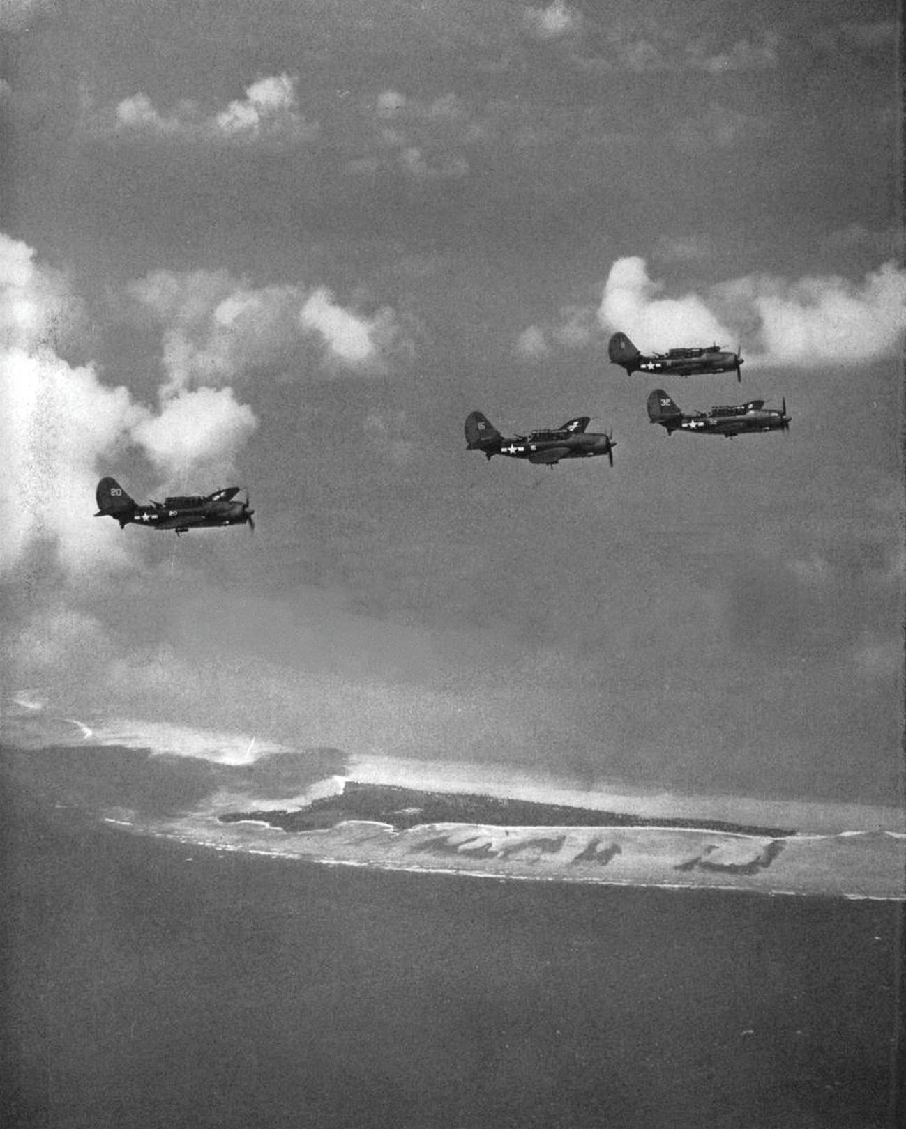 SB2C-1&nbsp;Helldivers&nbsp;of VB-17 in flight over Betio, Tarawa Atoll, in November 1943, while operating from the USS <em>Bunker Hill</em> (CV-17). <em>USN</em>