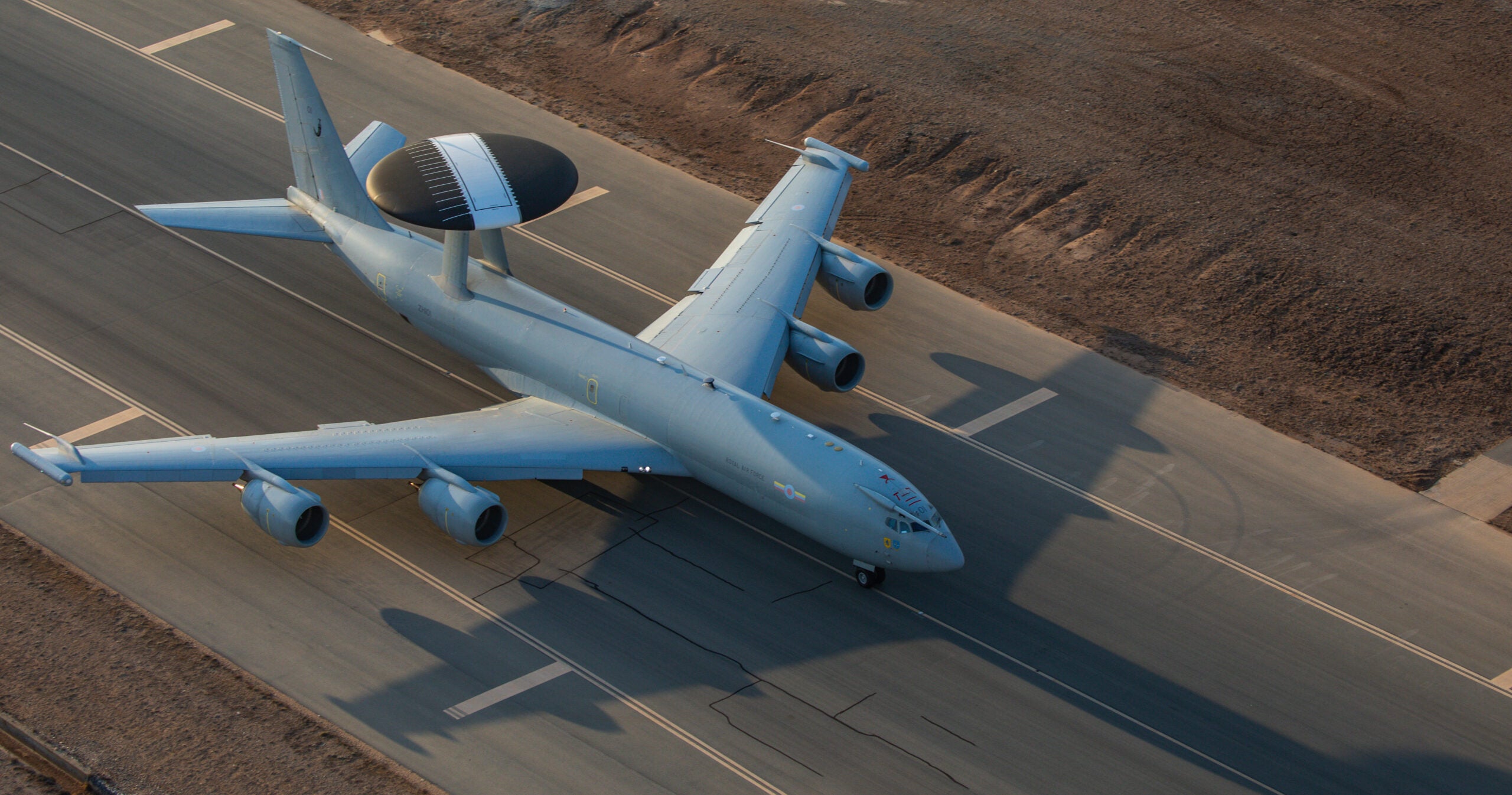 Pictured is a Boeing E-3D Sentry, aka AWACS, conducting a take-off and a fly-through at RAF Akrotiri.

This was before flying a mission in support of Operation Shader captured from a helicopter flown by 84 Squadron.

The E-3D was at RAF Akrotiri flying its final missions supporting Operations before returning to its home unit, RAF Waddington.

The E-3D Sentry entered RAF service in March 1991 as part of the RAFs Intelligence, Surveillance, Targeting and Reconnaissance fleet.  

Since then the Sentry aircraft have been involved in UK operations including Iraq, Afghanistan, Libya, the broader Middle East and the Caribbean, together with a NATO role.  

The Sentry is also known as the Airborne Warning and Control System or AWACS.

The E-3D Sentry was retired in 2021 and will be replaced in 2023 by a fleet of three Boeing E-7 Wedgetails that will operate from RAF Lossiemouth in Scotland.  

During the period between retirement and the Wedgetail becoming operational, the Intelligence, Surveillance, Targeting and Reconnaissance requirements will be covered by a combination of other aircraft and E-3s from our NATO partners.