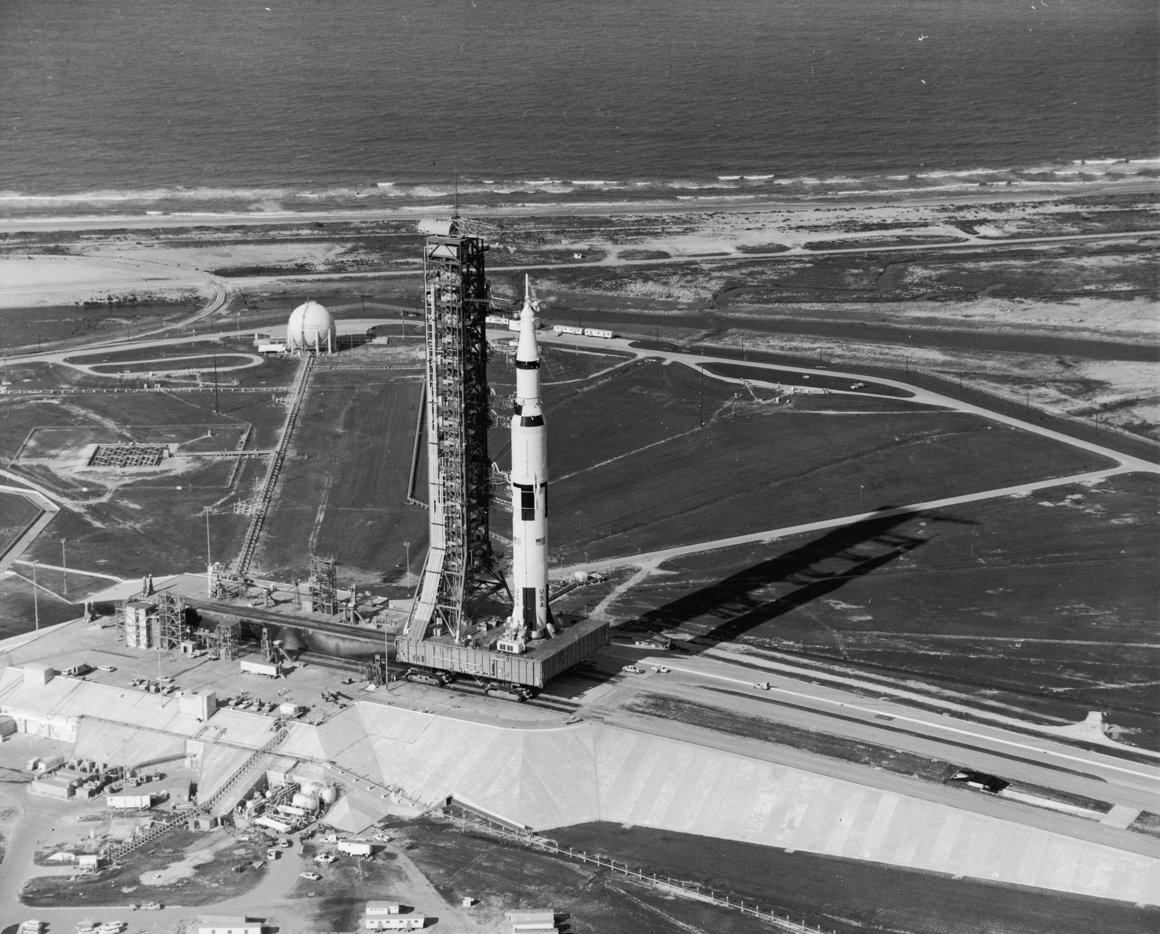 16th July 1969:  View of the Apollo 11 rocket standing with its gantry on the launch pad at Kennedy Space Center, Cape Canaveral, Florida. The rocket served the first American manned lunar mission, with Neil Armstrong, Michael Collins and Edwin Aldrin.  (Photo by Hulton Archive/Getty Images)