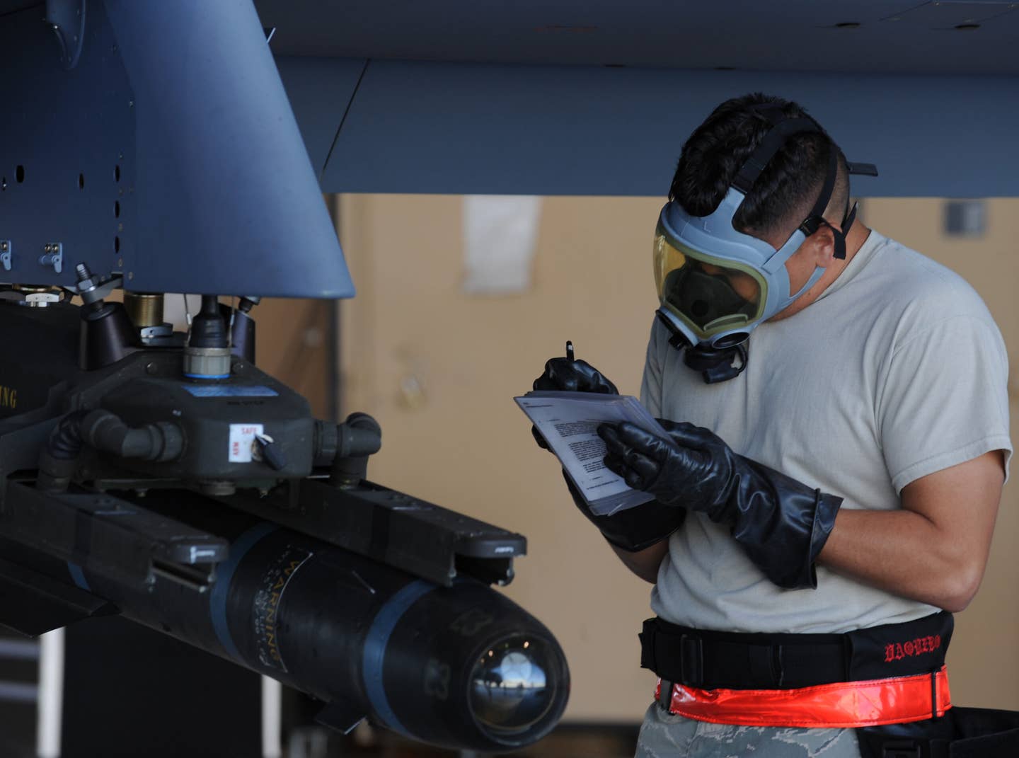 Staff Sgt. Bobby Domanski double checks a guided bomb unit-12 Paveway II laser-guided bomb onto the munitions rack during weapons load training April 22 at Creech Air Force Base, Nev. <em>Credit: U.S. Air Force photo/Senior Airman Nadine Y. Barclay</em>