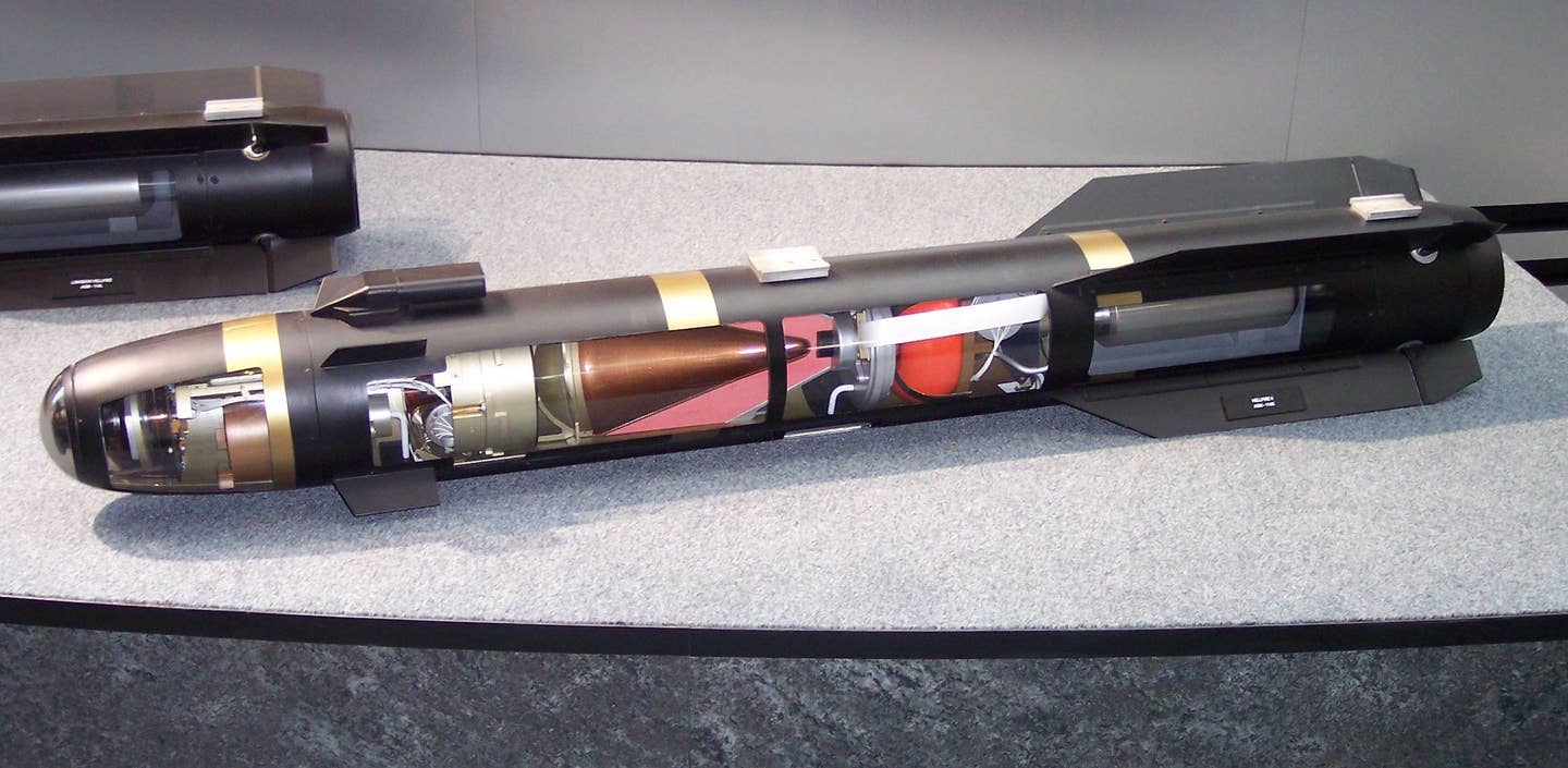 Hellfire II missile exposed through a transparent casing, showing laser homing&nbsp;guidance system&nbsp;in front, copper cone-shaped charge&nbsp;explosive in the middle, propulsion in the rear. <em>Credit: Wikimedia Commons</em>