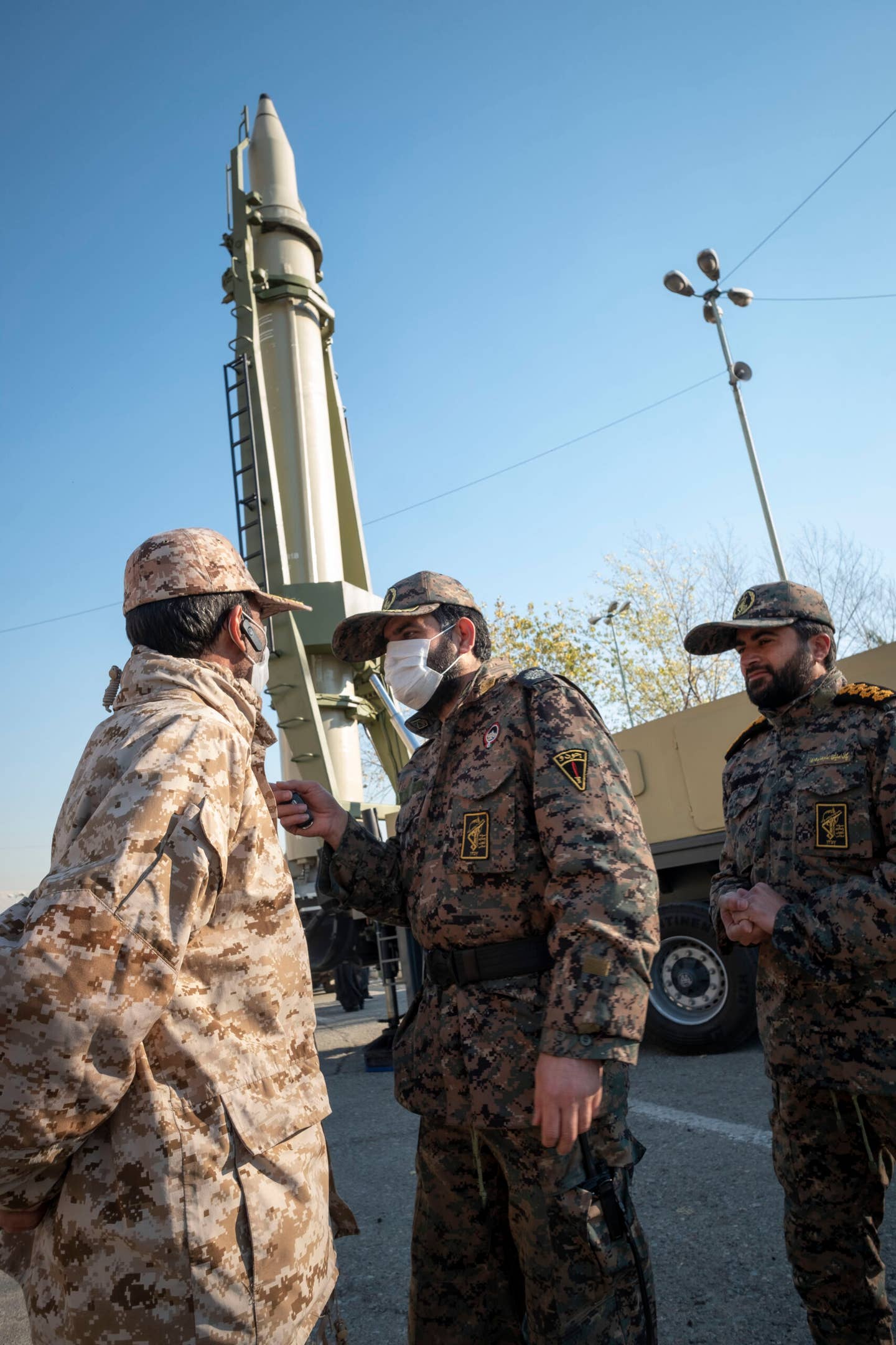 January 7, 2022, and Islamic Revolutionary Guard Corp military personnel talk as a Qiam SRBM is displayed in a military exhibition to mark the anniversary of the Iran missile attack on Al-Assad Air Base in Iraq. <em>Photo by Morteza Nikoubazl/NurPhoto via Getty Images</em>