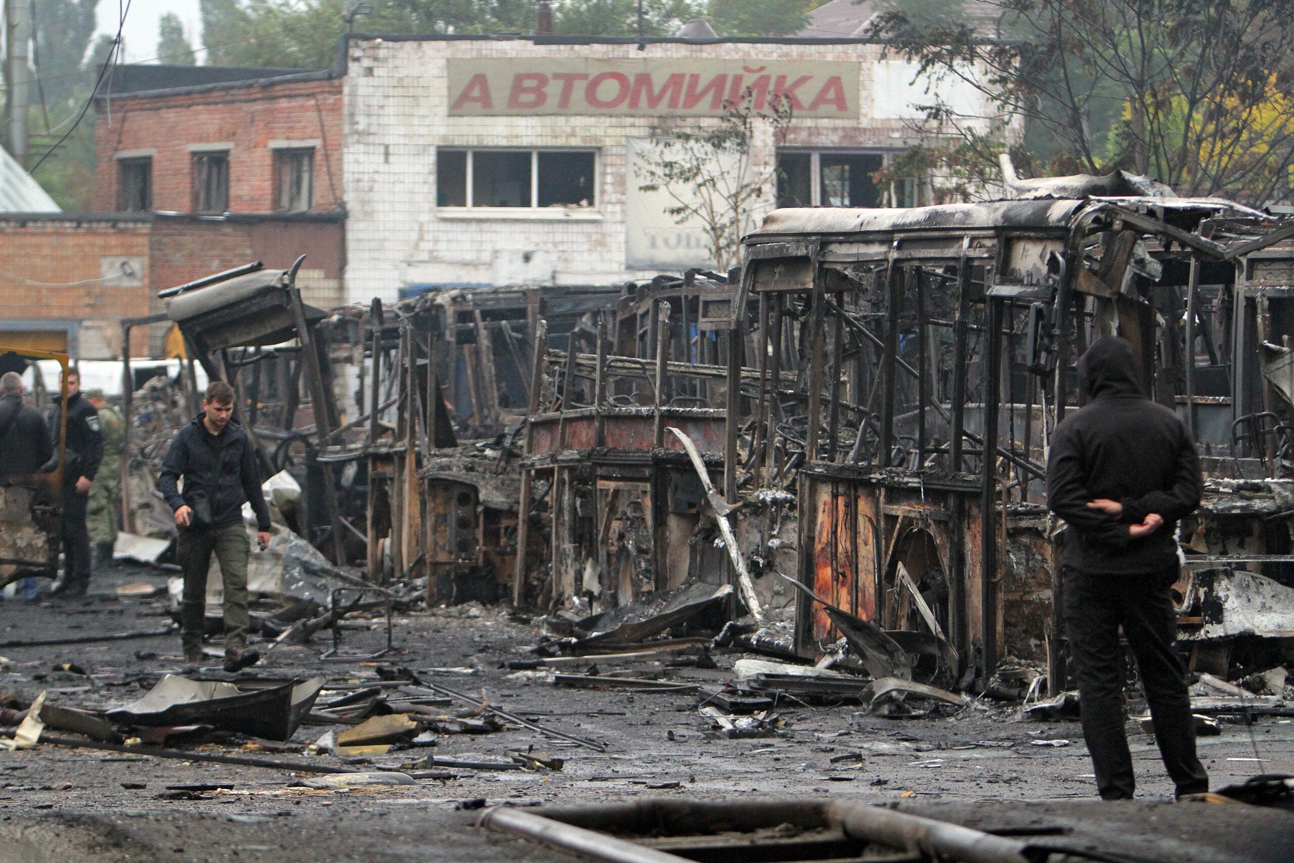 DNIPRO, UKRAINE - SEPTEMBER 29, 2022 - Burnt-out buses are pictured on the premises of a transport company after a Russian Iskander missile attack on Dnipro at night, Dnipro, central Ukraine. As reported, one person was killed and five people were injured in the strike. In the fire at the transport company, 52 buses burnt down while another 98 were damaged as a result of the missile attack. (Photo credit should read Mykola Miakshykov / Ukrinform/Future Publishing via Getty Images)