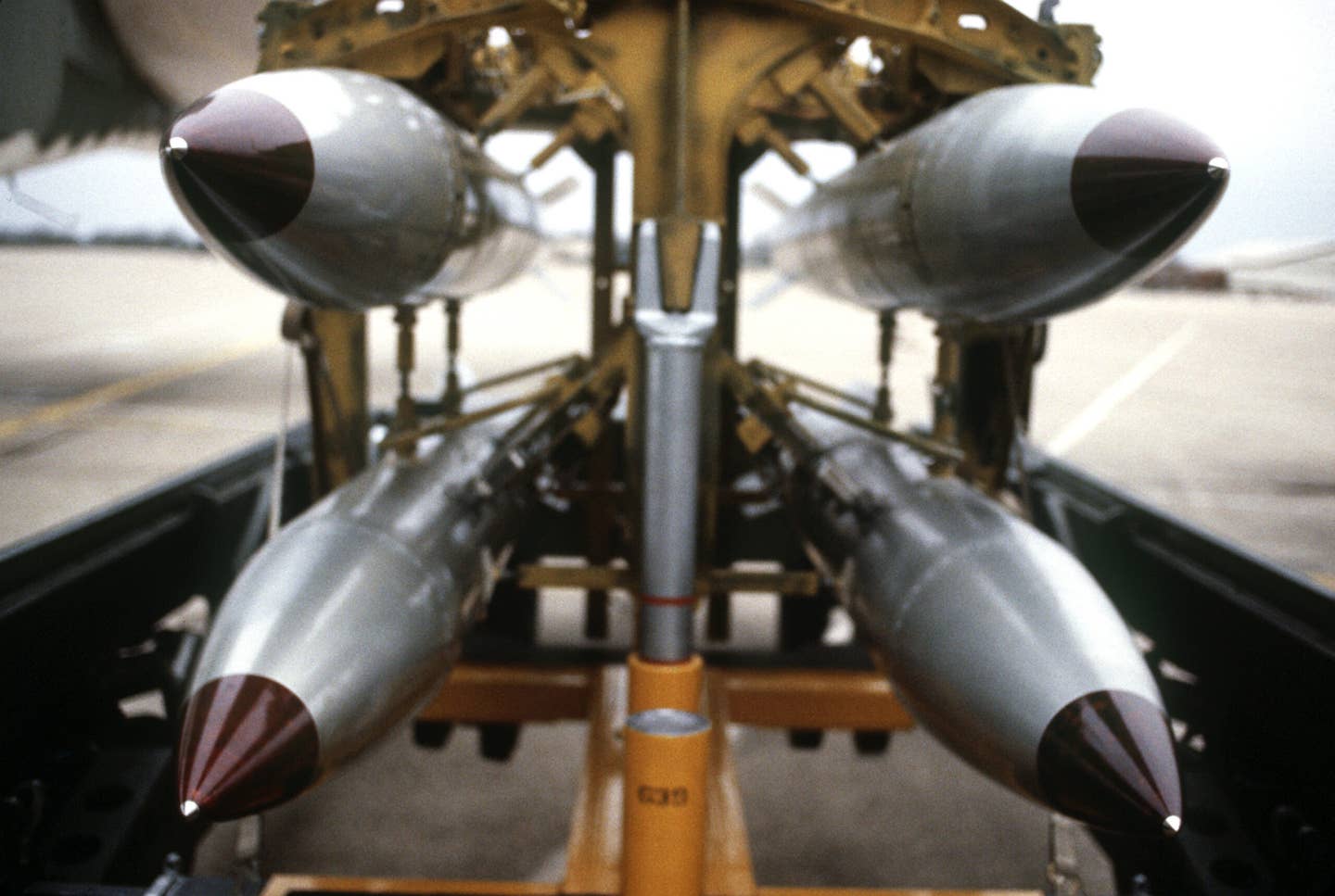 A frontal view of four B61 nuclear gravity bombs on a bomb cart. <em>Credit: Defense Department photo by SSGT PHIL SCHMITTEN&nbsp;</em>