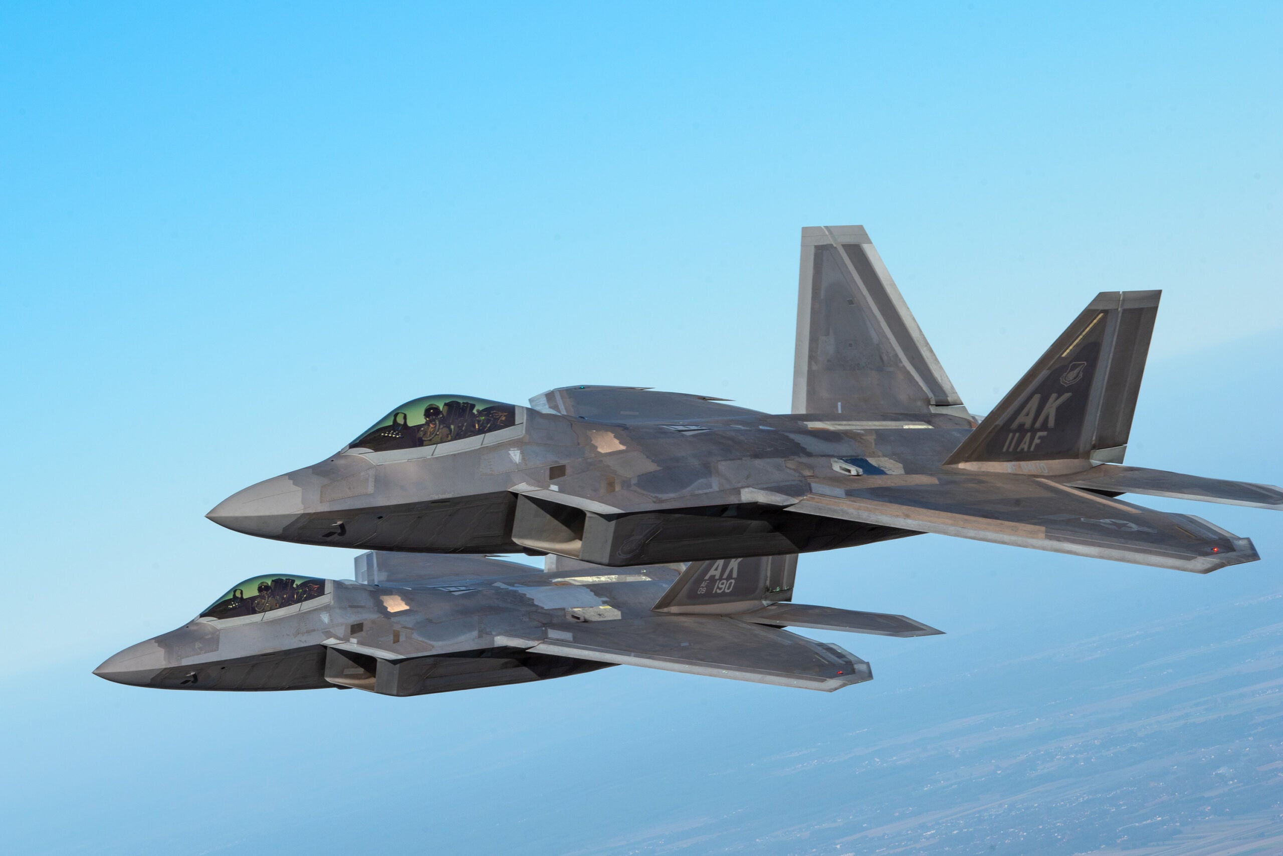 Two U.S. Air Force F-22 Raptors assigned to the 90th Expeditionary Fighter Squadron conduct a two-ship formation during the NATO Air Shielding media day, Oct. 12, 2022 at Łask Air Base, Poland. The Raptors uphold the Air Shielding mission alongside Polish F-16s and Italian Eurofighter Typhoons. The event showcased the importance of NATO’s Air Shielding mission and the interoperability among the U.S. and NATO Allies to international media through trilateral aerial demonstrations and interviews with service members. The U.S. remains dedicated to our security commitments with our NATO Alliance and postured to defend NATO territory. (U.S. Air Force photo by Staff Sergeant Danielle Sukhlall)