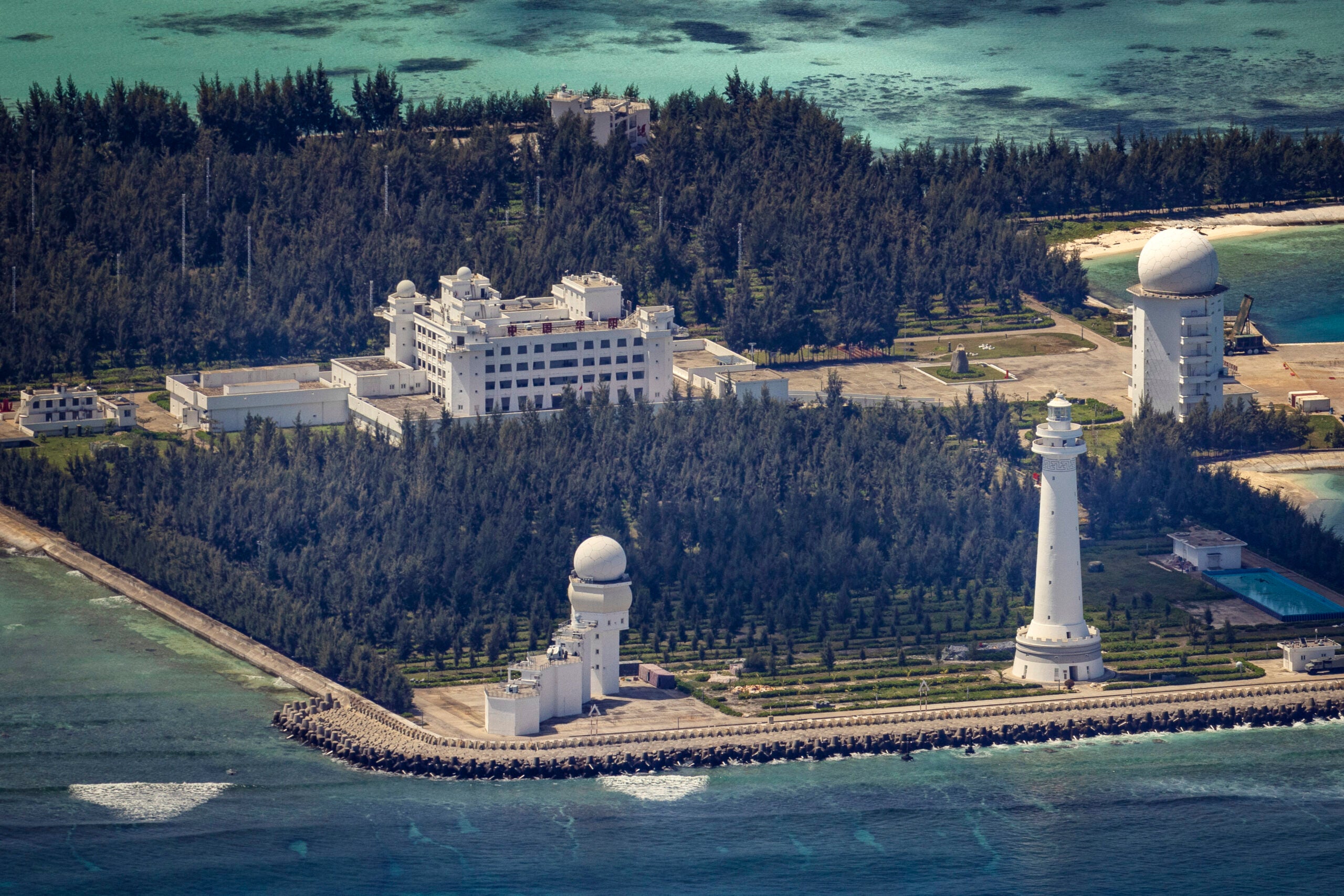 SPRATLY ISLANDS, AT SEA - OCTOBER 25: Buildings and structures are seen on the artificial island built by China in Cuarteron Reef on October 25, 2022 in Spratly Islands, South China Sea. China has progressively asserted its claim of ownership over disputed islands in the South China Sea by artificially increasing the size of islands, creating new islands and building ports, military outposts and airstrips. The South China sea is an important trade route and is of significant interest as geopolitical tensions remain high in the region. (Photo by Ezra Acayan/Getty Images)