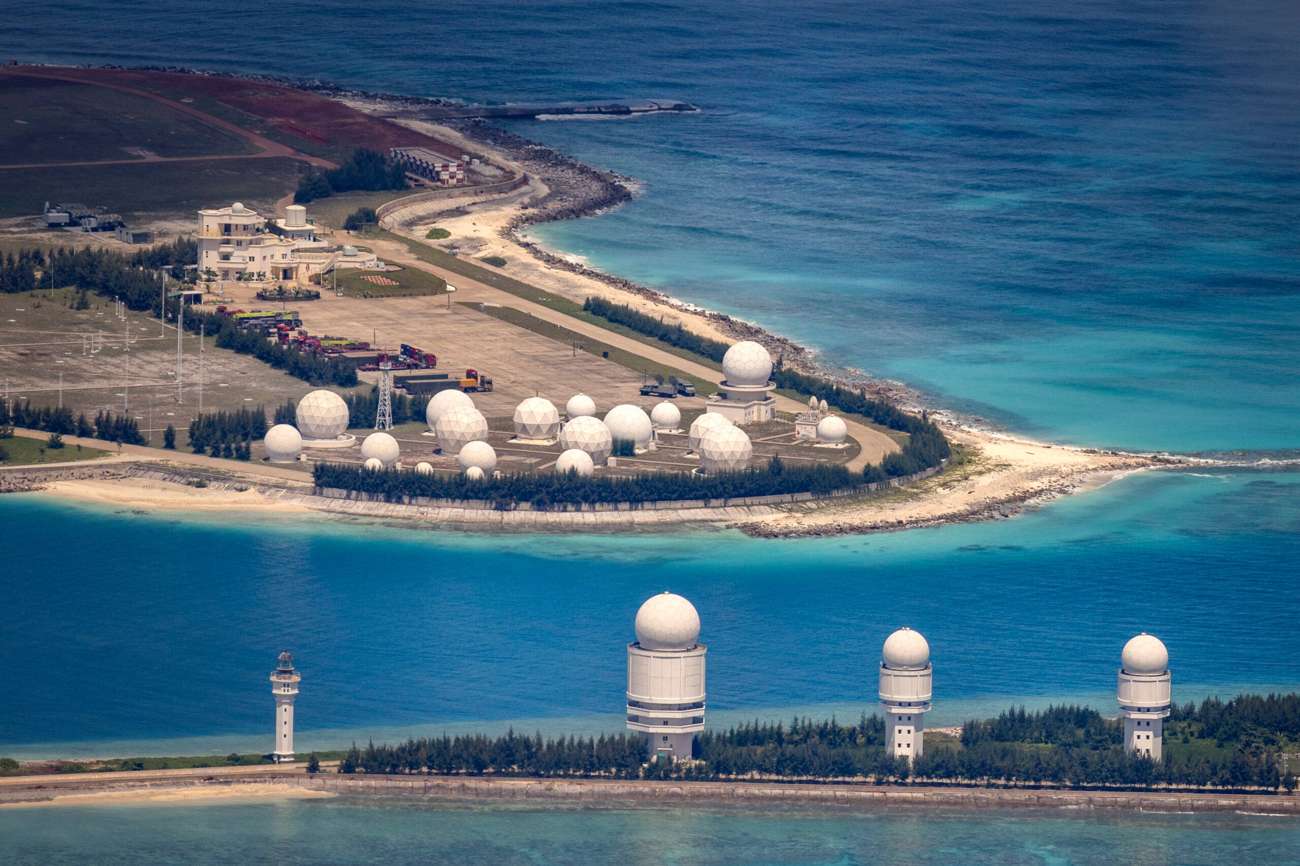 SPRATLY ISLANDS, AT SEA - OCTOBER 25: Buildings and structures are seen on the artificial island built by China in Fiery Cross Reef on October 25, 2022 in Spratly Islands, South China Sea. China has progressively asserted its claim of ownership over disputed islands in the South China Sea by artificially increasing the size of islands, creating new islands and building ports, military outposts and airstrips. The South China sea is an important trade route and is of significant interest as geopolitical tensions remain high in the region. (Photo by Ezra Acayan/Getty Images)
